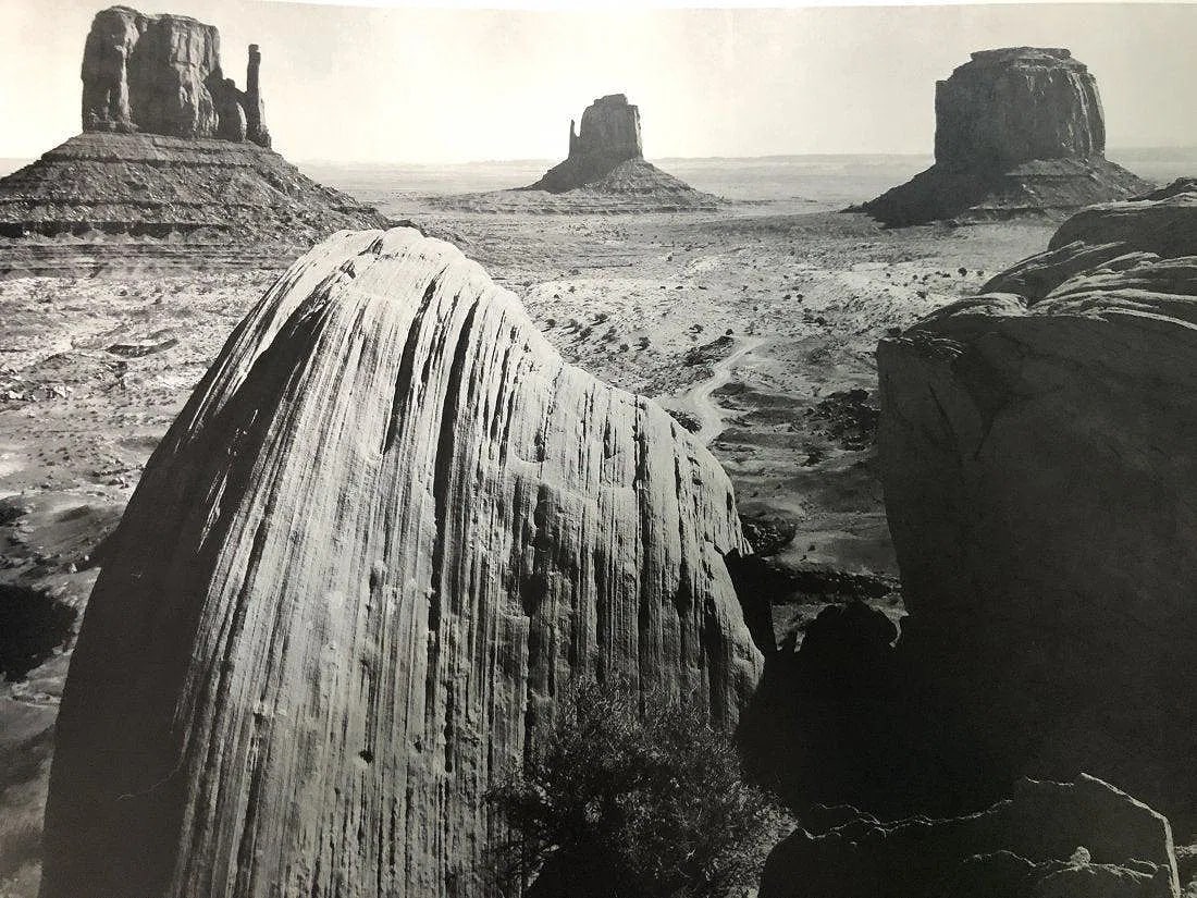 Ansel Adams - Monument Valley, Utah 1958: ANSEL ADAMS(B.1902-1984),Monument Valley,Utah 1958,Photo-litho,11.5"x15" Printed second half of 20th Century, Mounted to archival board