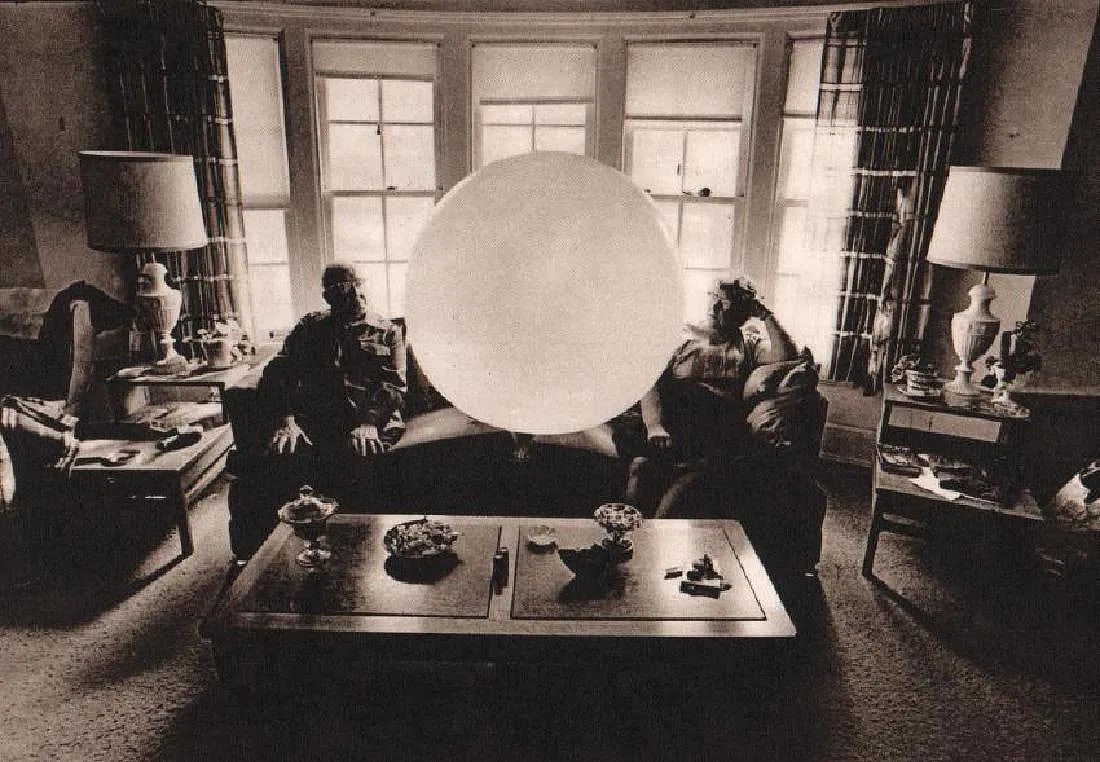 Krims, Leslie - Balloon Couple: Vintage Sheet-fed Gravure. From the satirical "The Little People of America" series. Image size: approx. 7" x 9"., Mounted to archival board