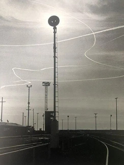 Ansel Adams - Rails and Jet Trails, California c.1953: ANSEL ADAMS (B.1902-1984), Rails and Jet Trails, Roseville, California c.1953, Photo-Litho, 11.5" x 9", Printed second half of 20th Century, mounted to archival board , Mounted to archival board