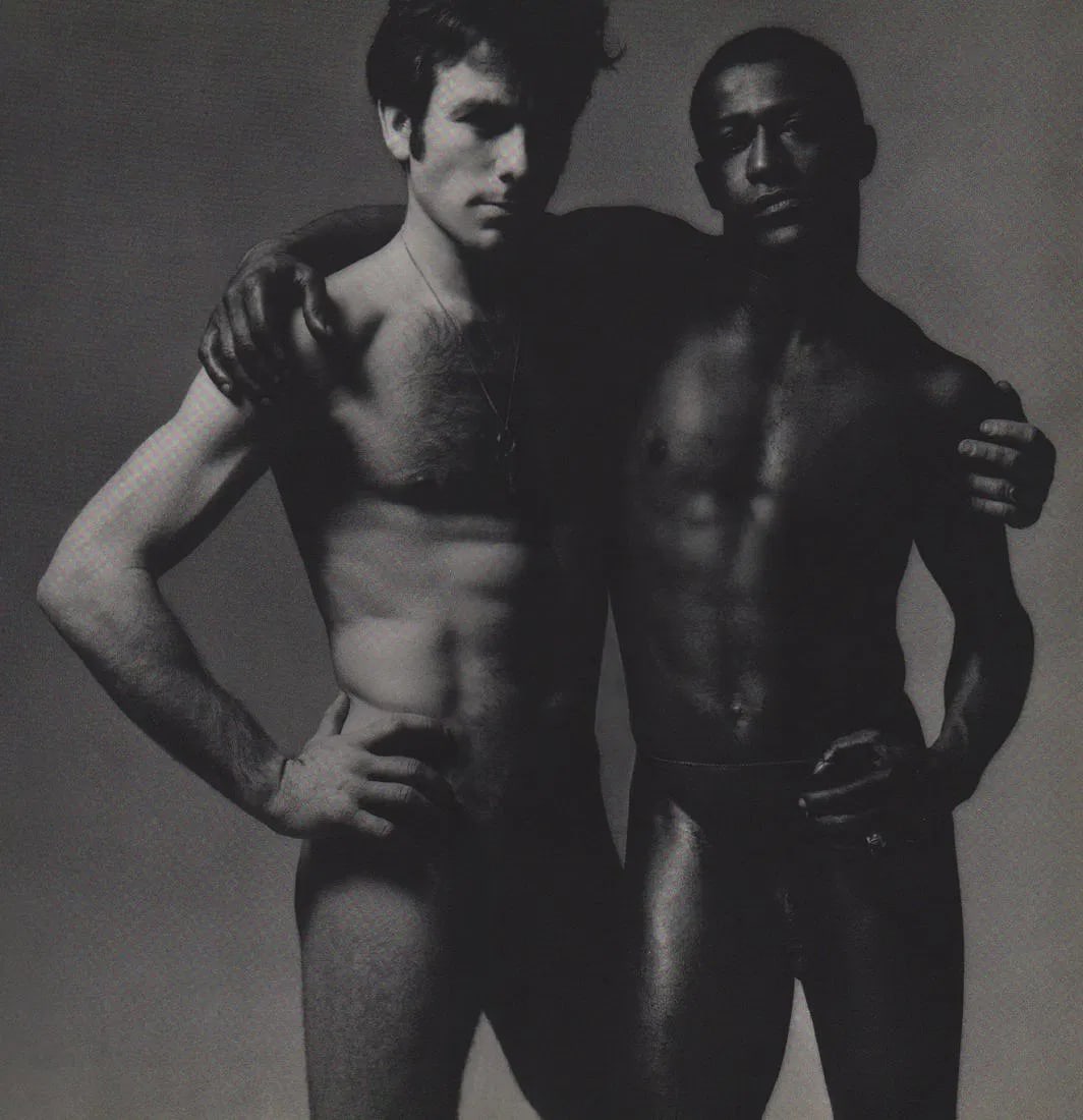 Victor Skrebneski - 2 Nude Men: Vintage Sheet-fed Gravure printed in the late 20th century. A sculptural and high-contrast masculine study. Image size: approx. 8.5" x 11"., Mounted to archival board