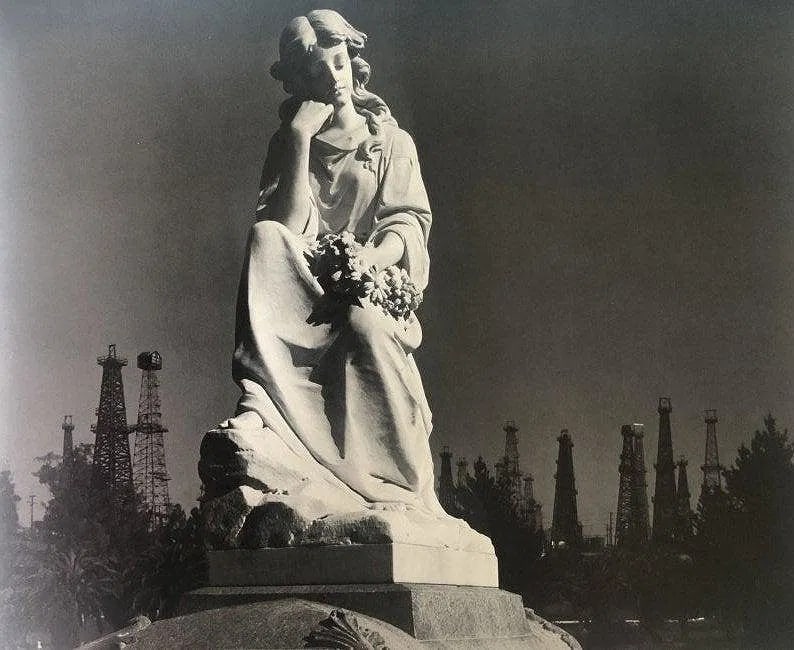 Ansel Adams - Cemetery Statue, California 1939: ANSEL ADAMS (B.1902-1984), Cemetery Statue and Oil Wells, Long Beach, California 1939, Photo-Litho, 10" x 12", Printed second half of 20th Century , Mounted to archival board