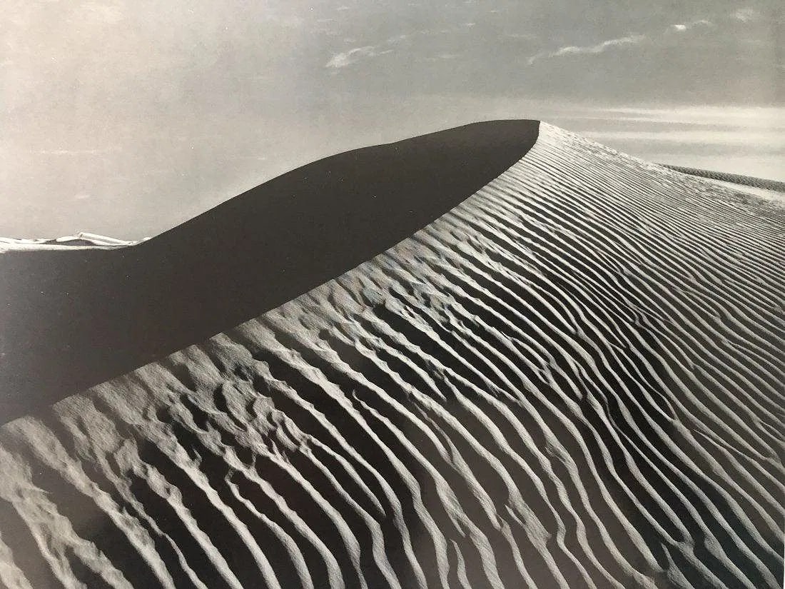 Ansel Adams - Dunes, New Mexico: ANSEL ADAMS (B.1902-1984), Dune, White Sands National Monument, New Mexico, Black and white photo on glossy paper, 7.5" x 9.5", Printed second half of 20th Century , Mounted to archival board