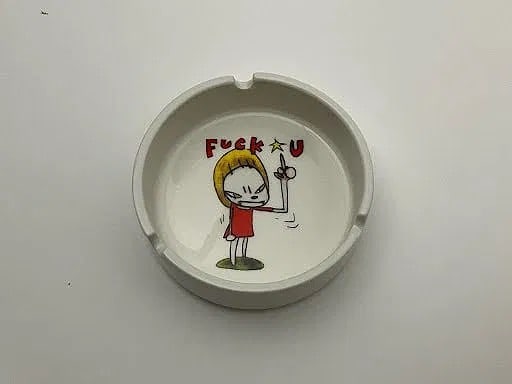 YOSHITOMO NARA 'F UCK U' CERAMIC ASHTRAY: Yoshitomo Nara 'Fuck U' ceramic ashtray. Measures 4" x 4" x 1/4".