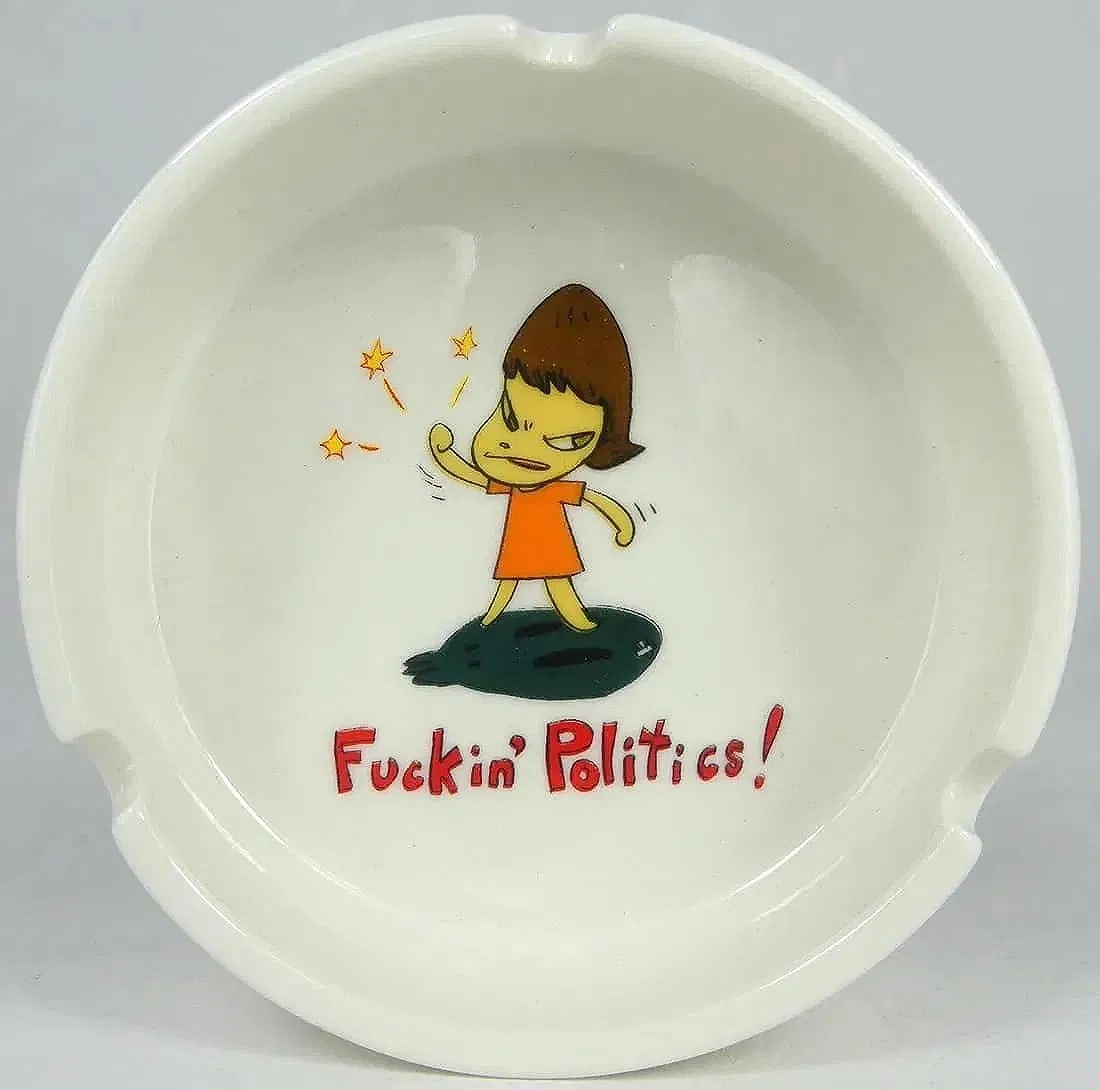 YOSHITOMO NARA 'F*CKIN POLITICS' CERAMIC ASHTRAY: Yoshitomo Nara 'Fuckin' Politics!' ceramic ashtray. Measures 4" x 4" x 1/4".