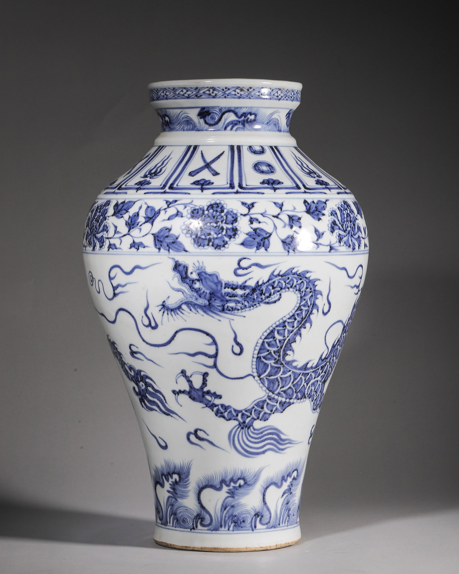 A BLUE AND WHITE PORCELAIN JAR WITH SINGLE DRAGON CHASING PEARL MOTIF, YUAN DYNASTY: L 27cm (10.63 in); H 44cm (17.32 in),Yuan blue and white jar with dish mouth and sand base. Decorated with rhombus pattern at rim, seawave horses on neck, treasure lotus panels and peony scrolls on sh