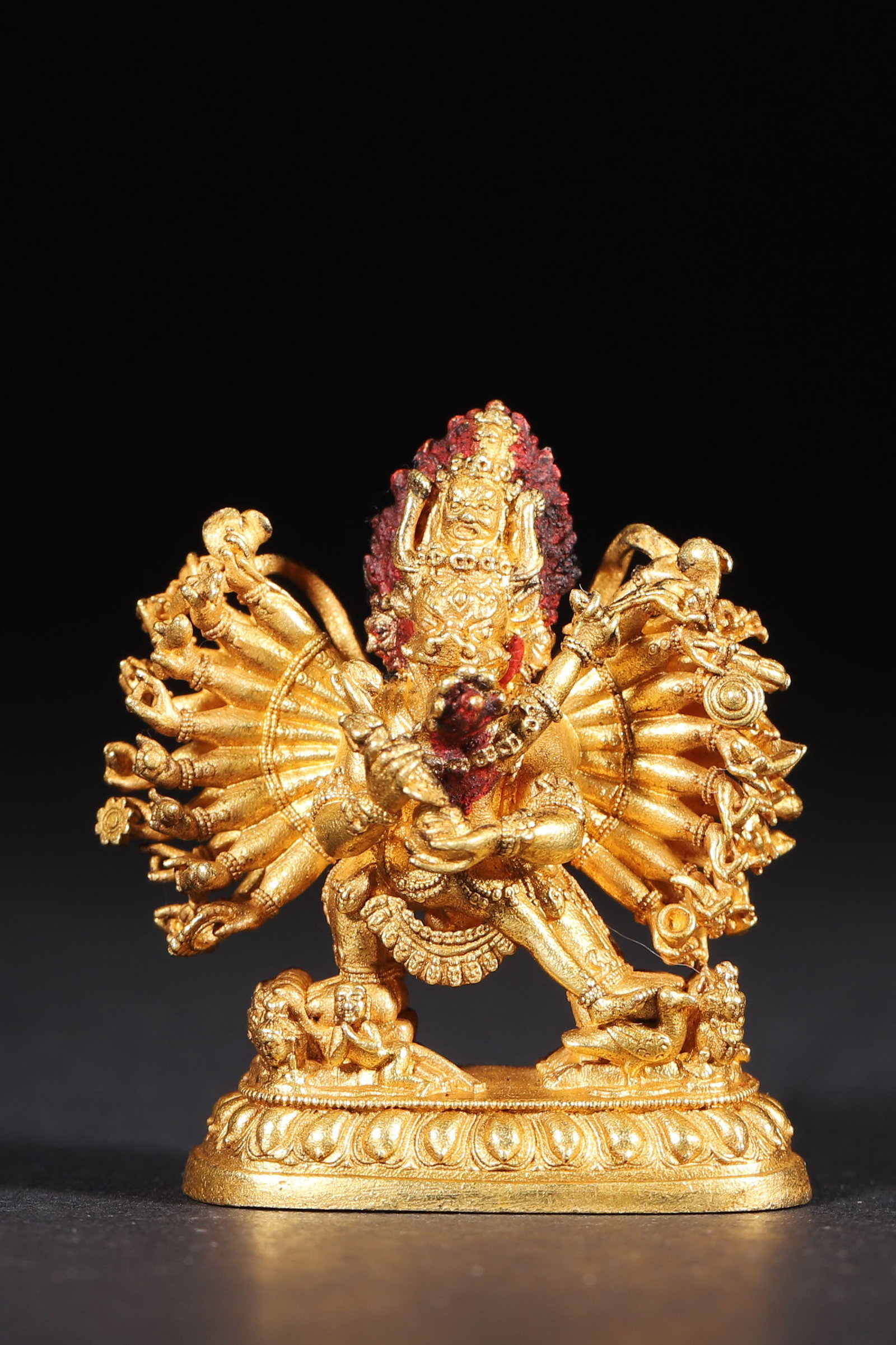 A Gilt Bronze Statue of Hevajra, Qing Dynasty: 3.5cm x 1.8cm x 3.9cm,35.0g (1.38in x 0.71in x 1.54in,WT 0.0772lb)This gilt bronze Hevajra statue features superb craftsmanship, depicting the deity in union, holding implements, trampling demons. A f
