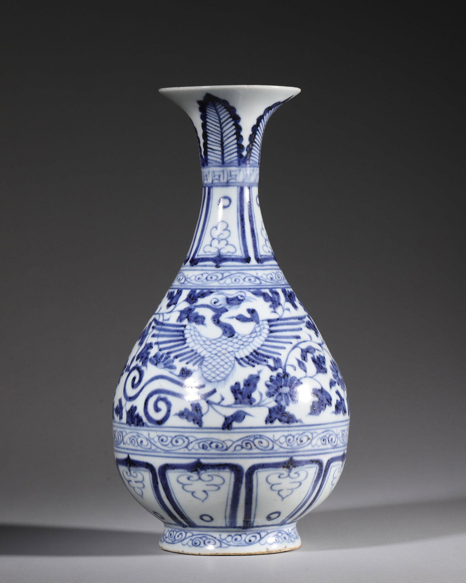 A BLUE AND WHITE PEAR-SHAPED VASE WITH TWIN PHOENIXES AMID FLORAL SCROLLS, YUAN DYNASTY: W 14cm (5.51 in); H 27cm (10.63 in),Classic Yuan pear-shaped yuhuchun vase with flared mouth, slender neck, plump belly and sandy base. Outer neck decorated with layered plantain leaves, key fret and 