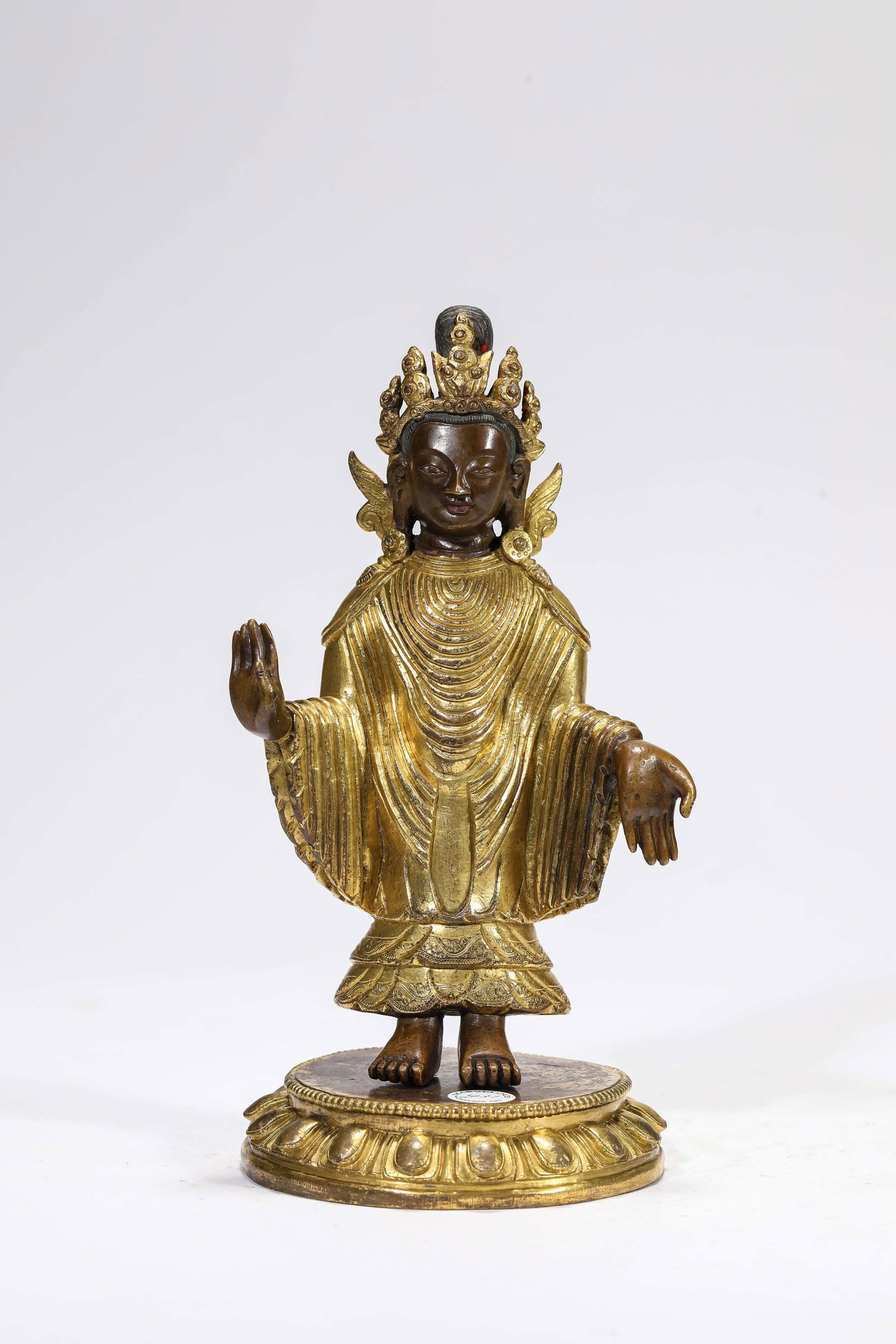 A Gilt-Bronze Figure of the Sandalwood Buddha: A Gilt-Bronze Figure of the Sandalwood Buddha Dimensions: Weight: 1370g. Length: 10.5 cm (4.13 in) x Width: 9.7 cm (3.82 in) x Height: 20.3 cm (7.99 in). All measurements are approximate.