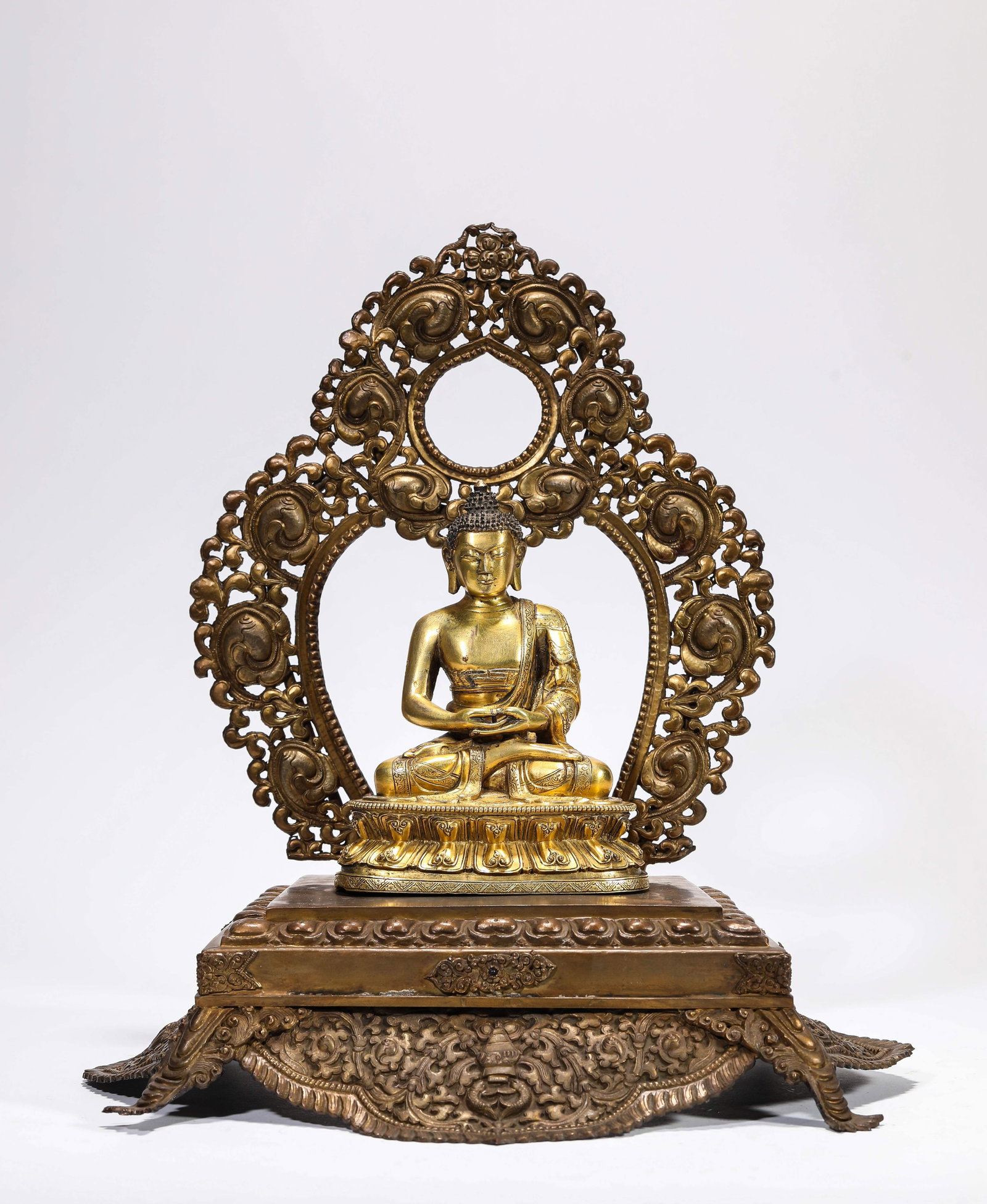 A Gilt-Bronze Figure of Shakyamuni: A Gilt-Bronze Figure of Shakyamuni Dimensions: Weight: 2.3kg. Length: 32.0 cm (12.60 in) x Width: 23.0 cm (9.06 in) x Height: 33.5 cm (13.19 in). Length: 12.0 cm (4.72 in) x Width: 8.3 cm (3.27 in) x