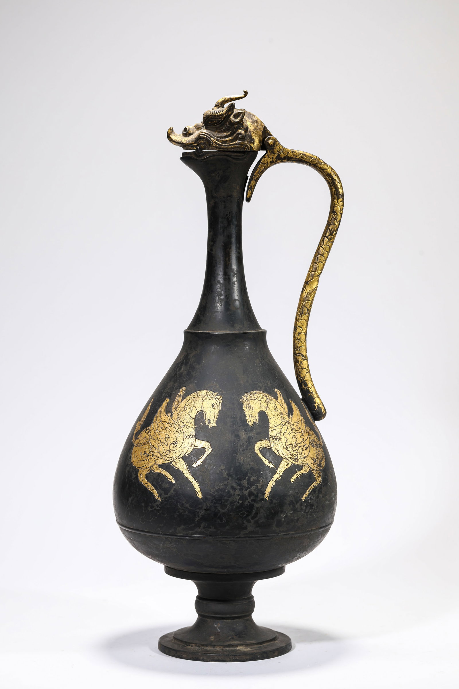A Gold-Inlaid Bronze 'Flying Horse and Dragon-Head' Pot: A Gold-Inlaid Bronze 'Flying Horse and Dragon-Head' Pot Dimensions: Weight: 3kg. Width: 18.8 cm (7.40 in) x Height: 49.7 cm (19.57 in). All measurements are approximate.