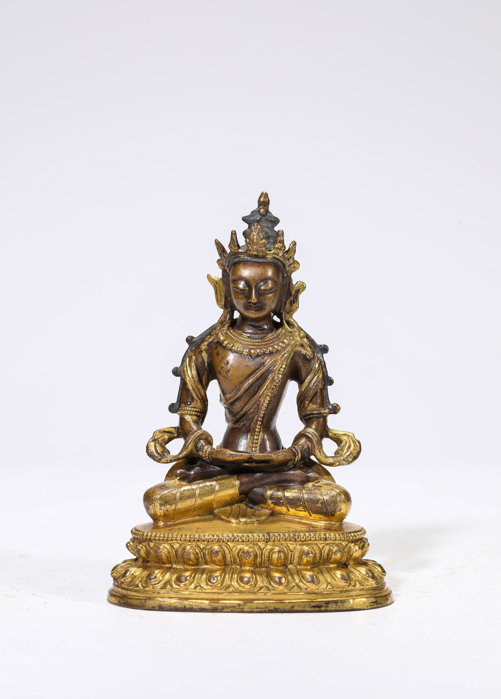 A Gilt-Bronze Figure of Amitayus: A Gilt-Bronze Figure of Amitayus Dimensions: Weight: 446g. Length: 8.3 cm (3.27 in) x Width: 5.8 cm (2.28 in) x Height: 11.7 cm (4.61 in). All measurements are approximate.