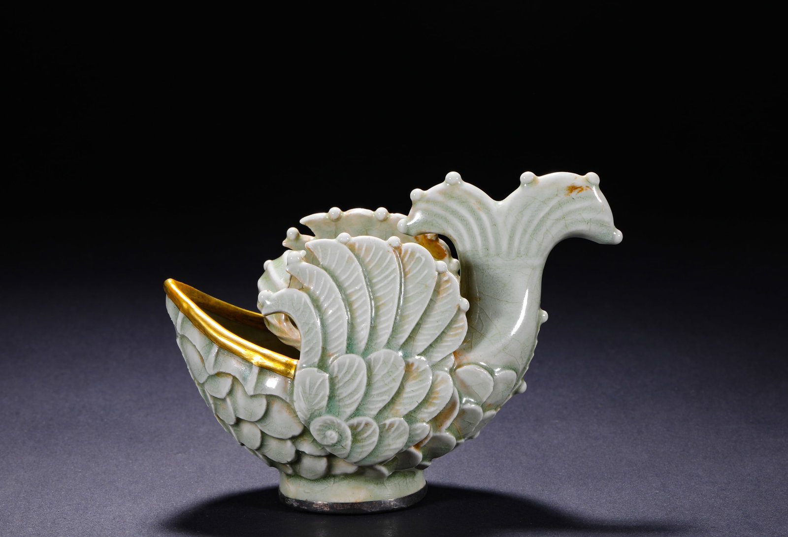 A Song Dynasty Yingqing-Glazed 'Fish Transforming into a Dragon' Cup: A Song Dynasty Yingqing-Glazed 'Fish Transforming into a Dragon' Cup H:10cm(3.94in) W:14cm(5.51in)This cup is made of shadowy blue celadon, with a warm and transparent glaze and natural crackle. It is