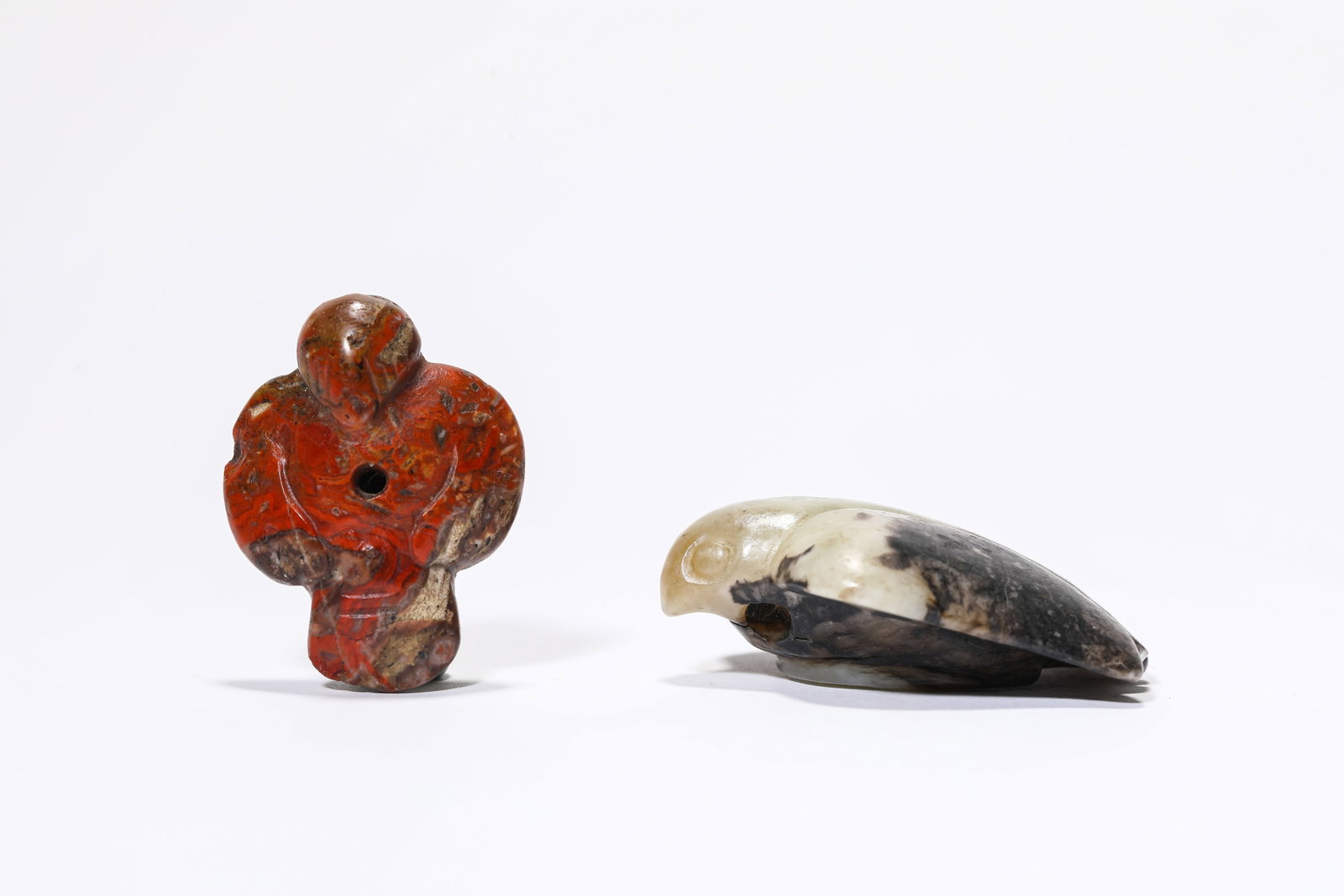 A Group of Jade and Agate Owls: A Group of Jade and Agate Owls Dimensions: Width: 4.5 cm (1.77 in) x Height: 4.7 cm (1.85 in). Width: 2.8 cm (1.10 in) x Height: 3.7 cm (1.46 in). All measurements are approximate.