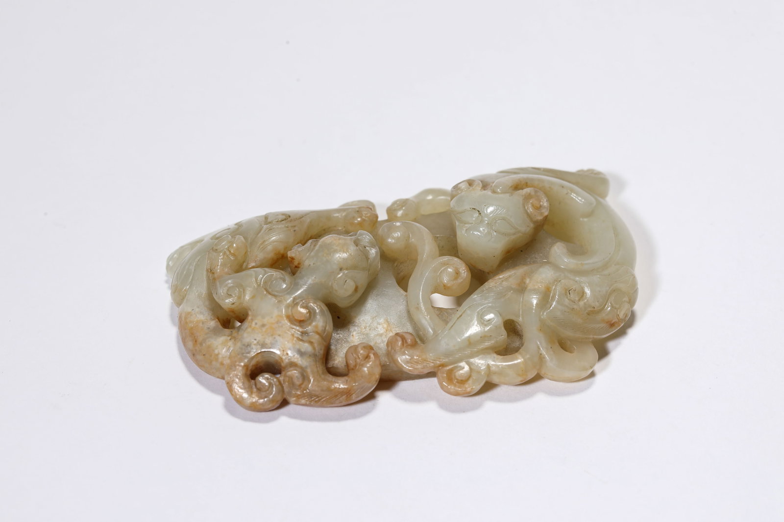 A Jade 'Double Dragon' 'Heart-Shaped' Pendant: A Jade 'Double Dragon' 'Heart-Shaped' Pendant Dimensions: Width: 7.4 cm (2.91 in) x Height: 4.6 cm (1.81 in). All measurements are approximate.