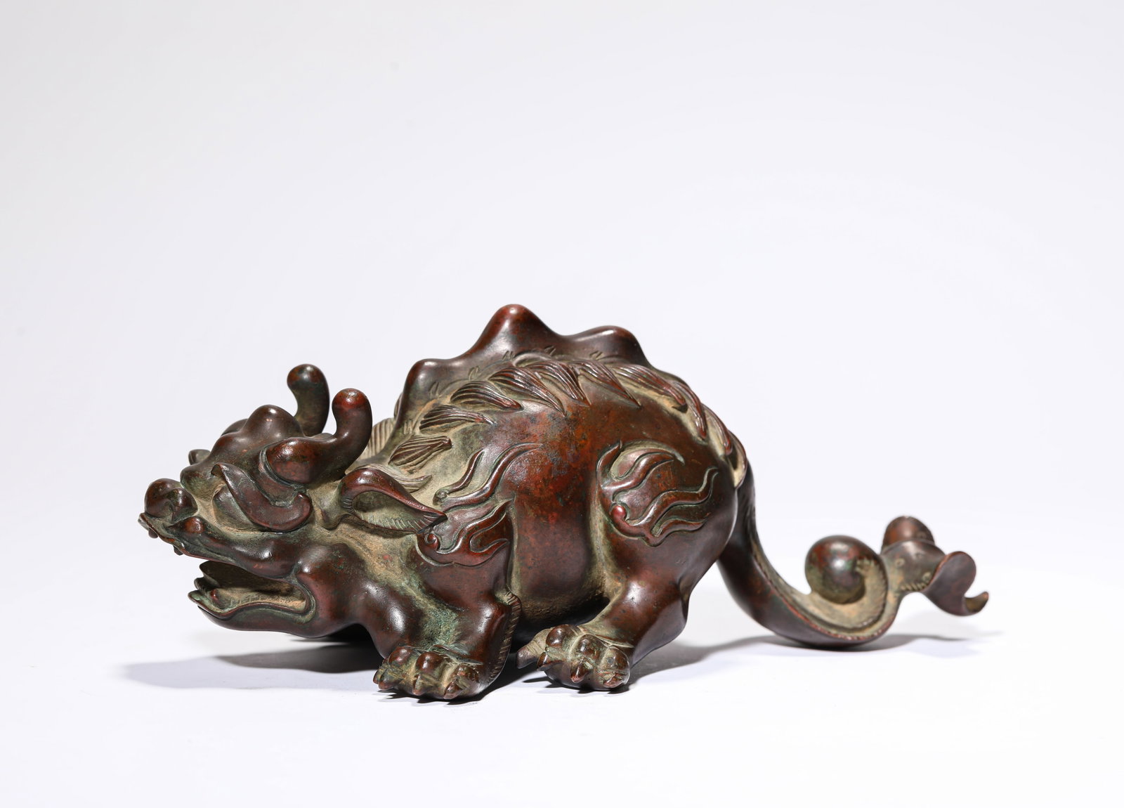 A Bronze 'Auspicious Beast': A Bronze 'Auspicious Beast' Dimensions: Weight: 1685g. Length: 21.8 cm (8.58 in) x Width: 11.4 cm (4.49 in) x Height: 8.8 cm (3.46 in). All measurements are approximate.