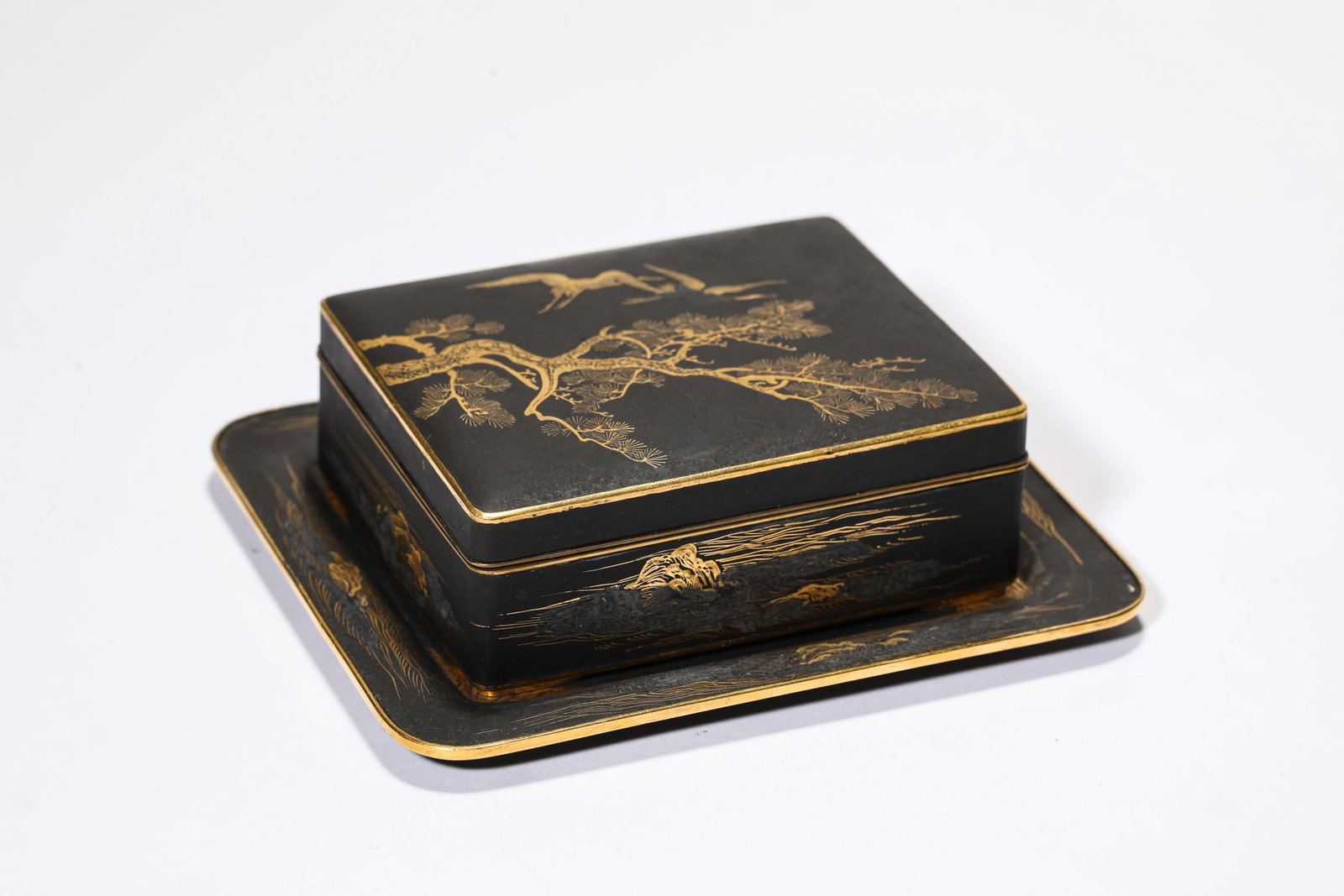 A Gilt-Bronze 'Pine and Crane' Covered Box: A Gilt-Bronze 'Pine and Crane' Covered Box Dimensions: Weight: 493g. Length: 13.0 cm (5.12 in) x Width: 11.2 cm (4.41 in). Length: 9.6 cm (3.78 in) x Width: 8.0 cm (3.15 in) x Height: 3.6 cm (1.42 in)