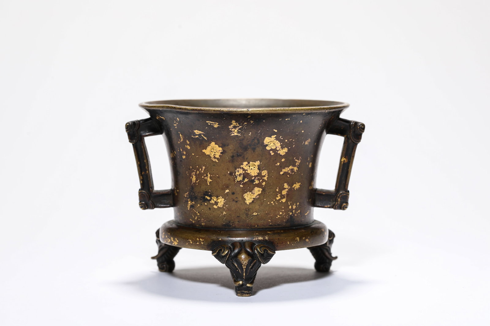 A Bronze 'Gold-Speckled' Tripod Censer with Flanges: A Bronze 'Gold-Speckled' Tripod Censer with Flanges Dimensions: Weight: 577g. Length: 12.4 cm (4.88 in) x Width: 10.9 cm (4.29 in) x Height: 9.2 cm (3.62 in). All measurements are approximate.