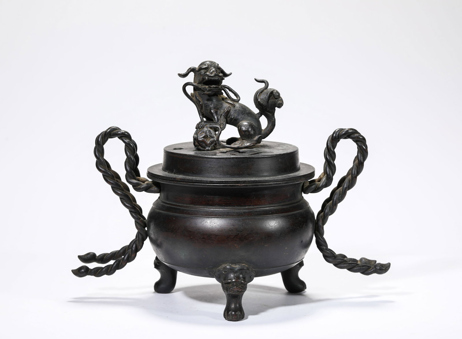 A Bronze 'Lion-Form Finial' Censer: A Bronze 'Lion-Form Finial' Censer Dimensions: Weight: 2.45kg. Length: 31.8 cm (12.52 in) x Width: 17.0 cm (6.69 in) x Height: 24.5 cm (9.65 in). All measurements are approximate.