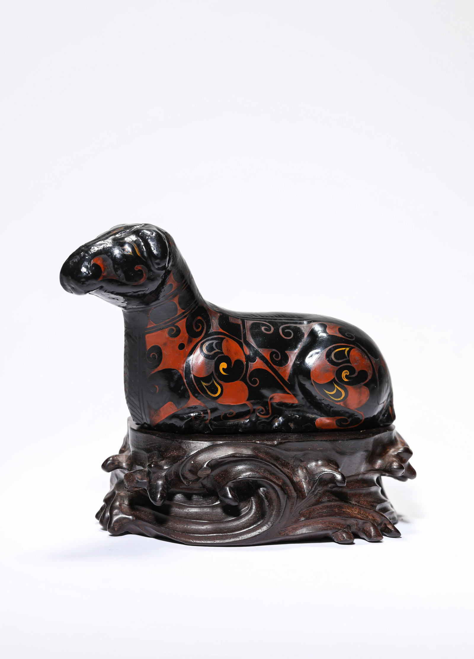 A Painted Pottery and Lacquer Ram: A Painted Pottery and Lacquer Ram Dimensions: Length: 14.3 cm (5.63 in) x Width: 4.5 cm (1.77 in) x Height: 7.9 cm (3.11 in). All measurements are approximate.