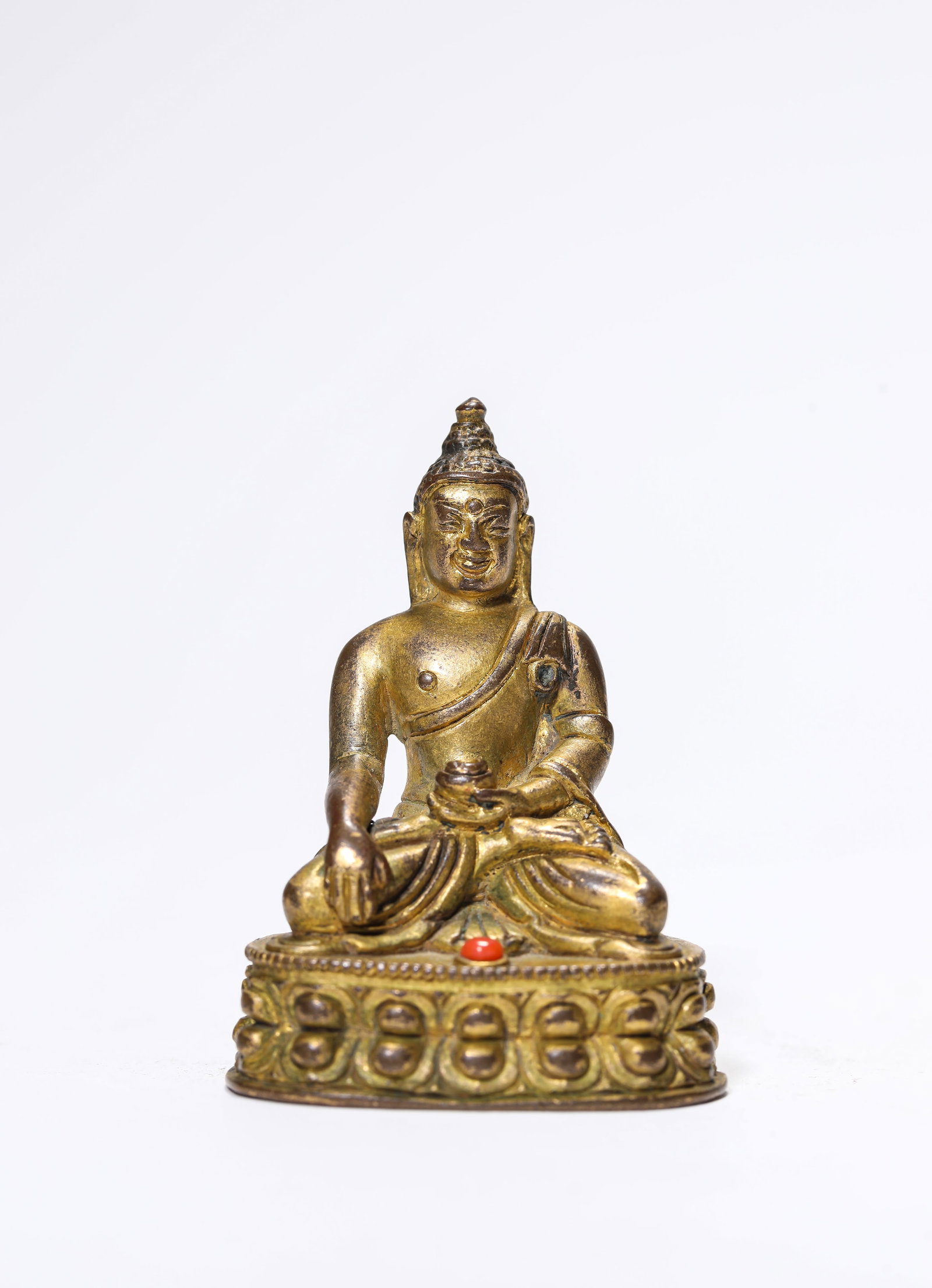 A Gilt-Bronze Figure of Bhaisajyaguru: A Gilt-Bronze Figure of Bhaisajyaguru Dimensions: Weight: 78g. Length: 4.0 cm (1.57 in) x Width: 2.8 cm (1.10 in) x Height: 5.4 cm (2.13 in). All measurements are approximate.