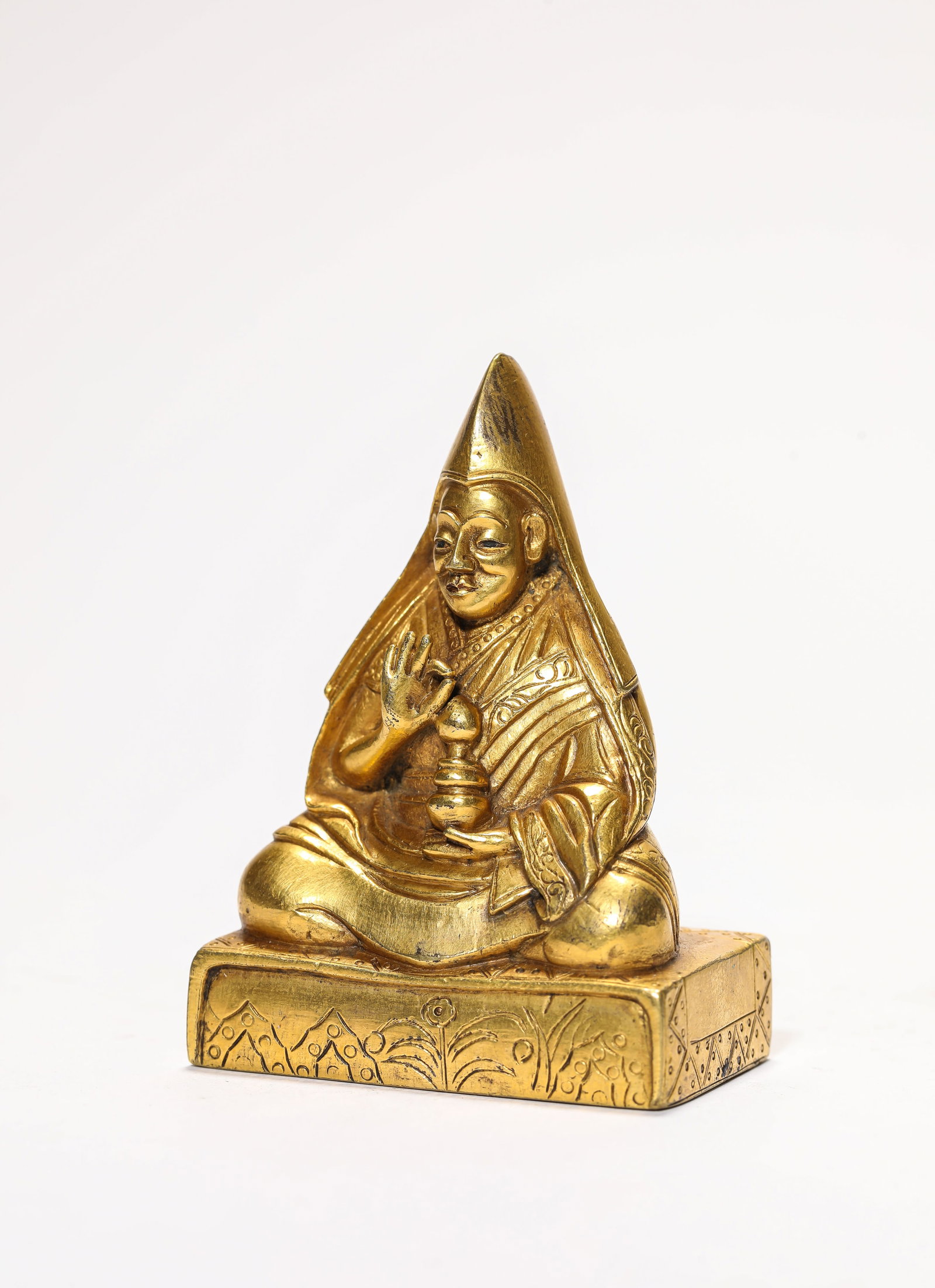 A Gilt-Bronze Figure of a Lama: A Gilt-Bronze Figure of a Lama Dimensions: Weight: 220g. Length: 5.7 cm (2.24 in) x Width: 3.5 cm (1.38 in) x Height: 7.9 cm (3.11 in). All measurements are approximate.