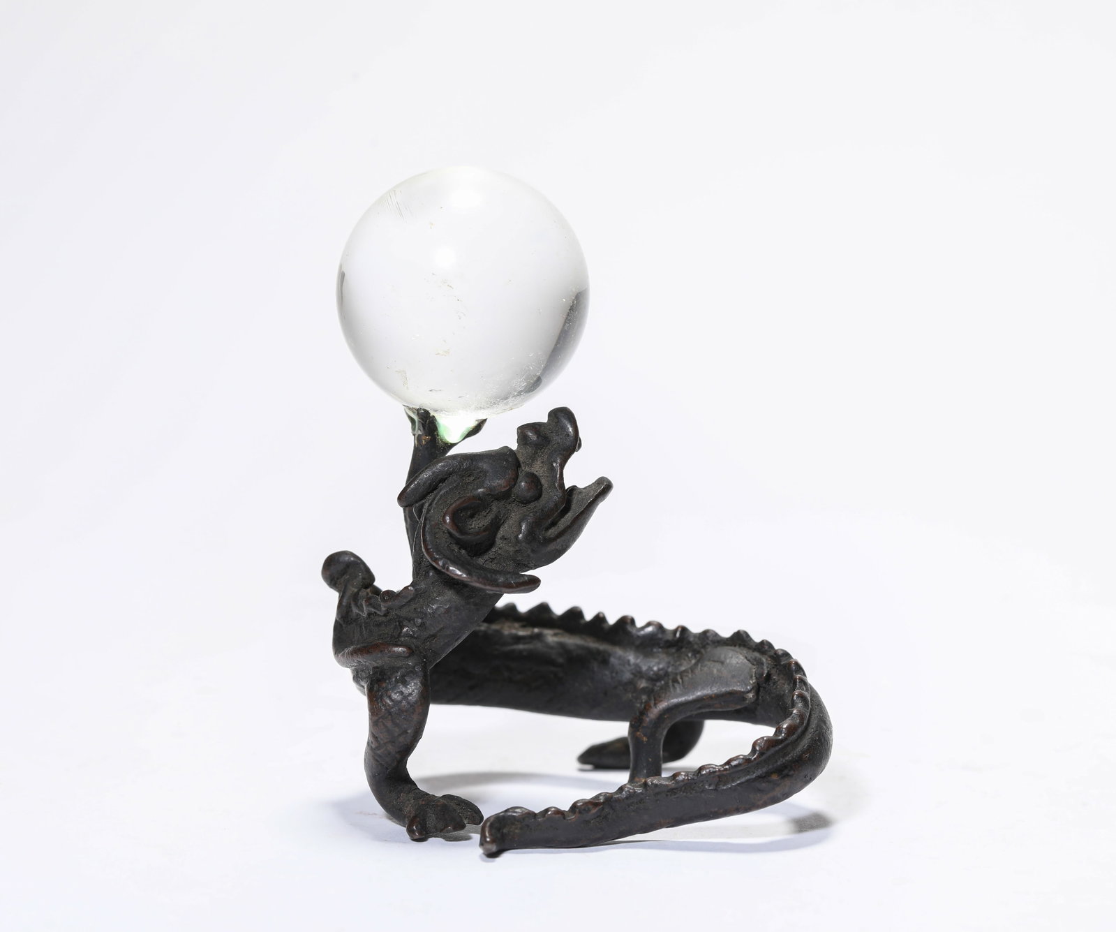 A Bronze 'Dragon Base' with Rock Crystal: A Bronze 'Dragon Base' with Rock Crystal Dimensions: Weight: 123g. Length: 6.1 cm (2.40 in) x Width: 5.6 cm (2.20 in) x Height: 8.0 cm (3.15 in). All measurements are approximate.