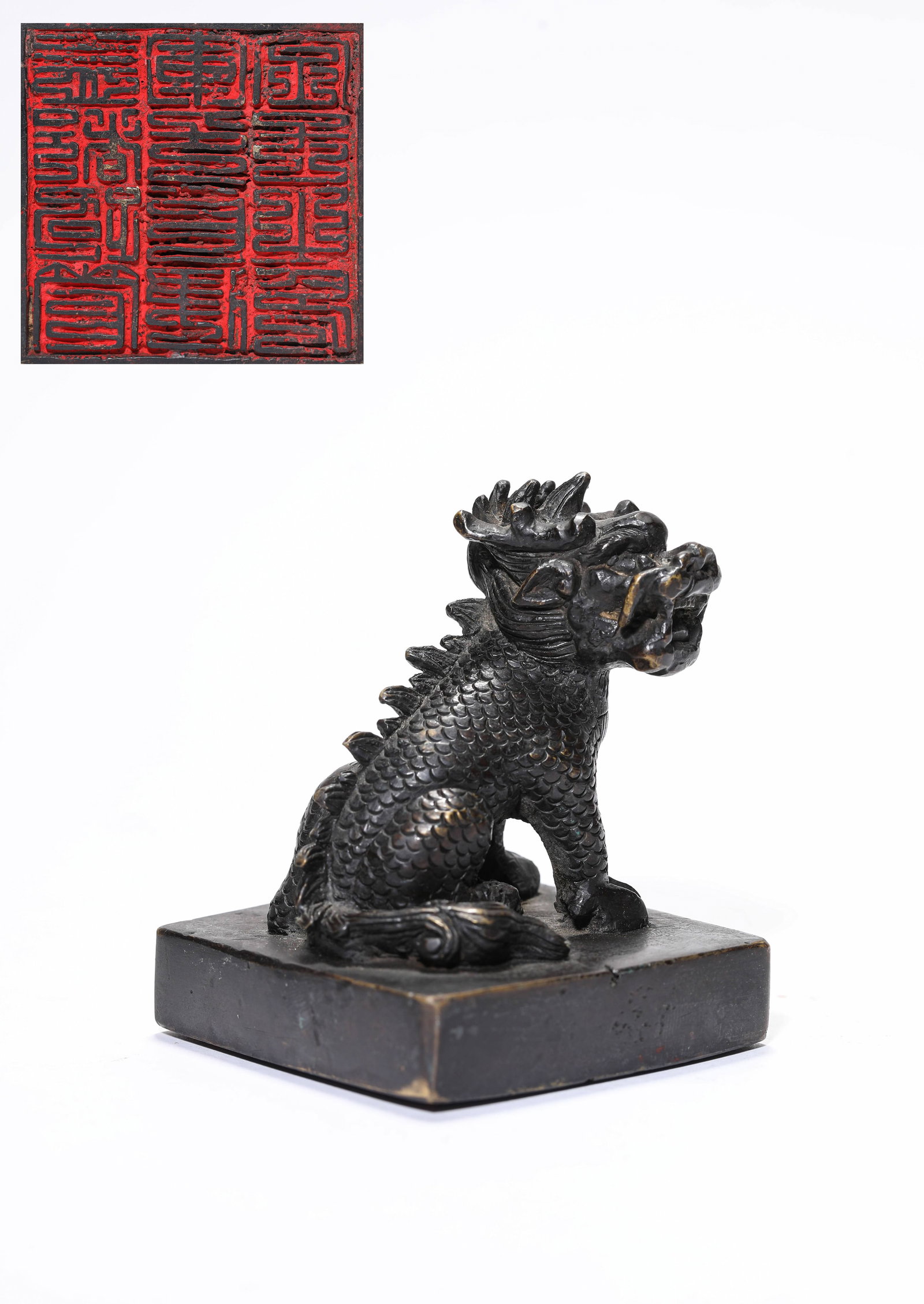 A Bronze 'Kylin-Form Finial' Seal: A Bronze 'Kylin-Form Finial' Seal Dimensions: Weight: 776g. Length: 6.4 cm (2.52 in) x Width: 6.2 cm (2.44 in) x Height: 7.9 cm (3.11 in). All measurements are approximate.