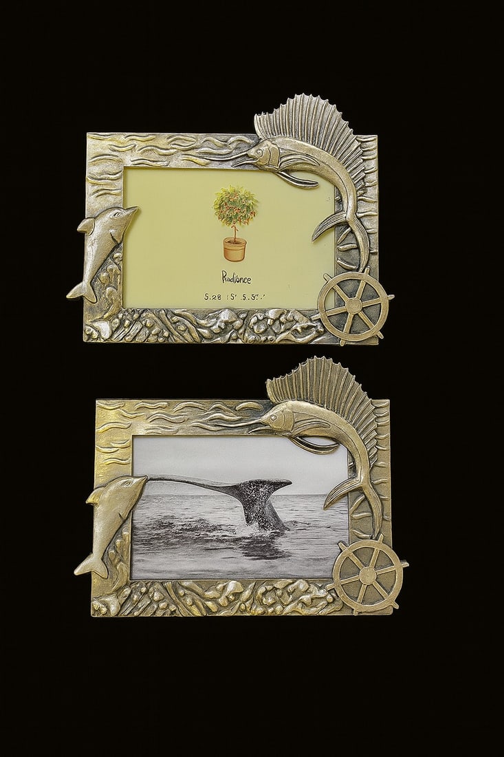 NAUTICAL FISH & DOLPHIN PICTURE FRAMES: Beautiful set of 2 nautical-themed picture frames featuring detailed dolphin, marlin, and ship wheel designs in a silver-tone finish. Each frame captures a coastal, ocean-inspired look perfect for bea