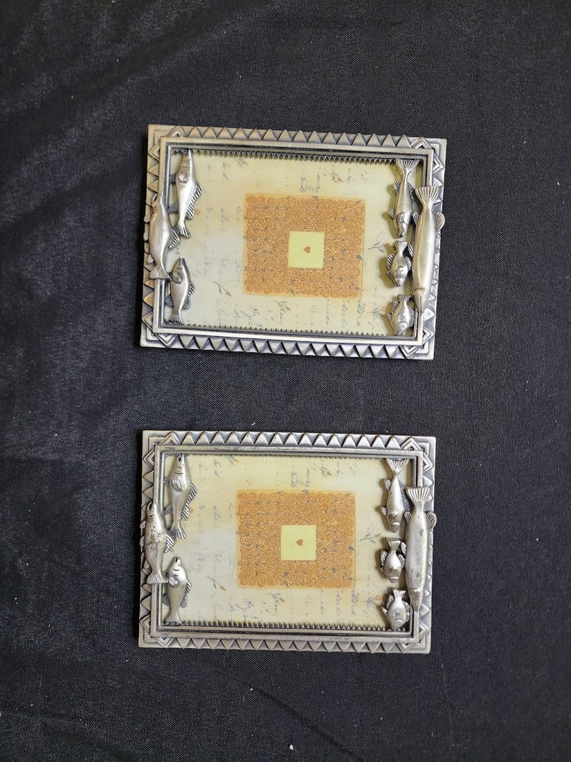 Pair of Fish-Themed Metal Picture Frames: Attractive set of two silver-tone metal picture frames featuring detailed fish designs along the top and bottom borders. Perfect for fishing enthusiasts or rustic cabin décor. Each frame holds a 5&rd