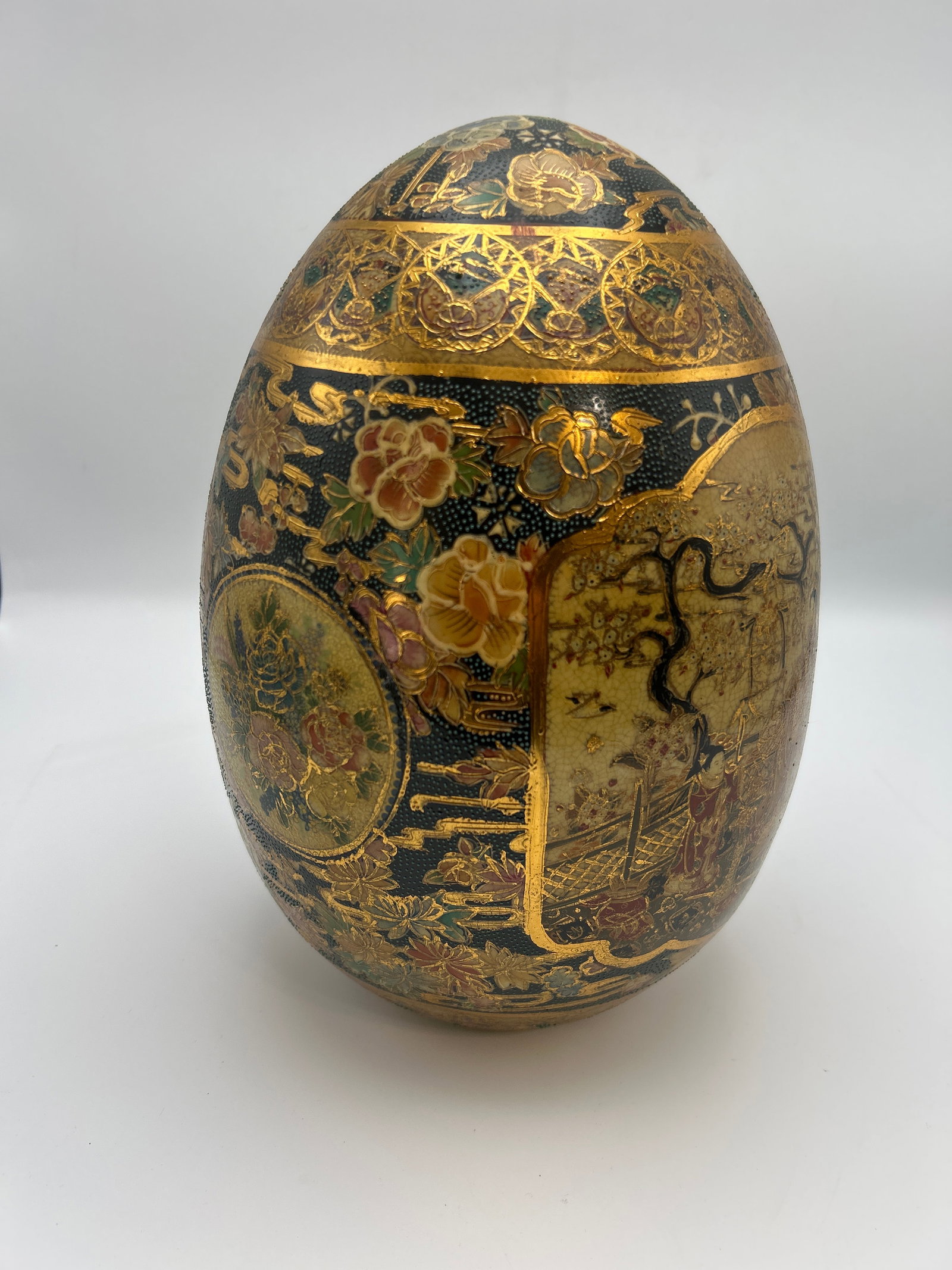 Large Satsuma-Style Porcelain Egg: Large hand-painted porcelain egg-form covered vessel with elaborate figural decoration in a Satsuma-inspired style. Approximate measurements are stated from the tape-measure reference photographs.
