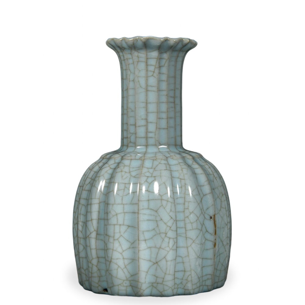 SONG DYNASTY GUAN WARE MELON-RIBBED VASE WITH PETAL-FORM MOUTH, INSCRIBED BY THE QIANLONG EMPEROR: Song Dynasty Guan Ware Melon-Ribbed Vase with Petal-Form Mouth, Inscribed by the Qianlong Emperor Dimensions: H: 7 3/4 in (20 cm); W: 5 in (13 cm) This refined small vase exemplifies the meditative