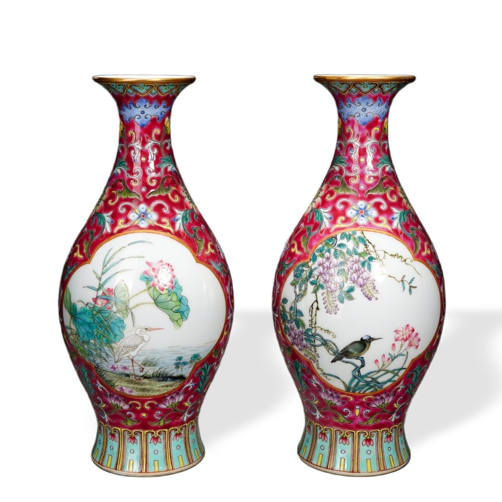 PAIR OF YONGZHENG FAMILLE ROSE 'CRANE AND LOTUS / BIRD AND WISTERIA' OLIVE-FORM VASES ON RUBY: Pair of Yongzheng Famille Rose 'Crane and Lotus / Bird and Wisteria' Olive-Form Vases on Ruby Sgraffito Ground Dimensions: H: 8 1/4 in (21 cm); W: 3 1/2 in (9 cm) This refined pair of olive-form vases