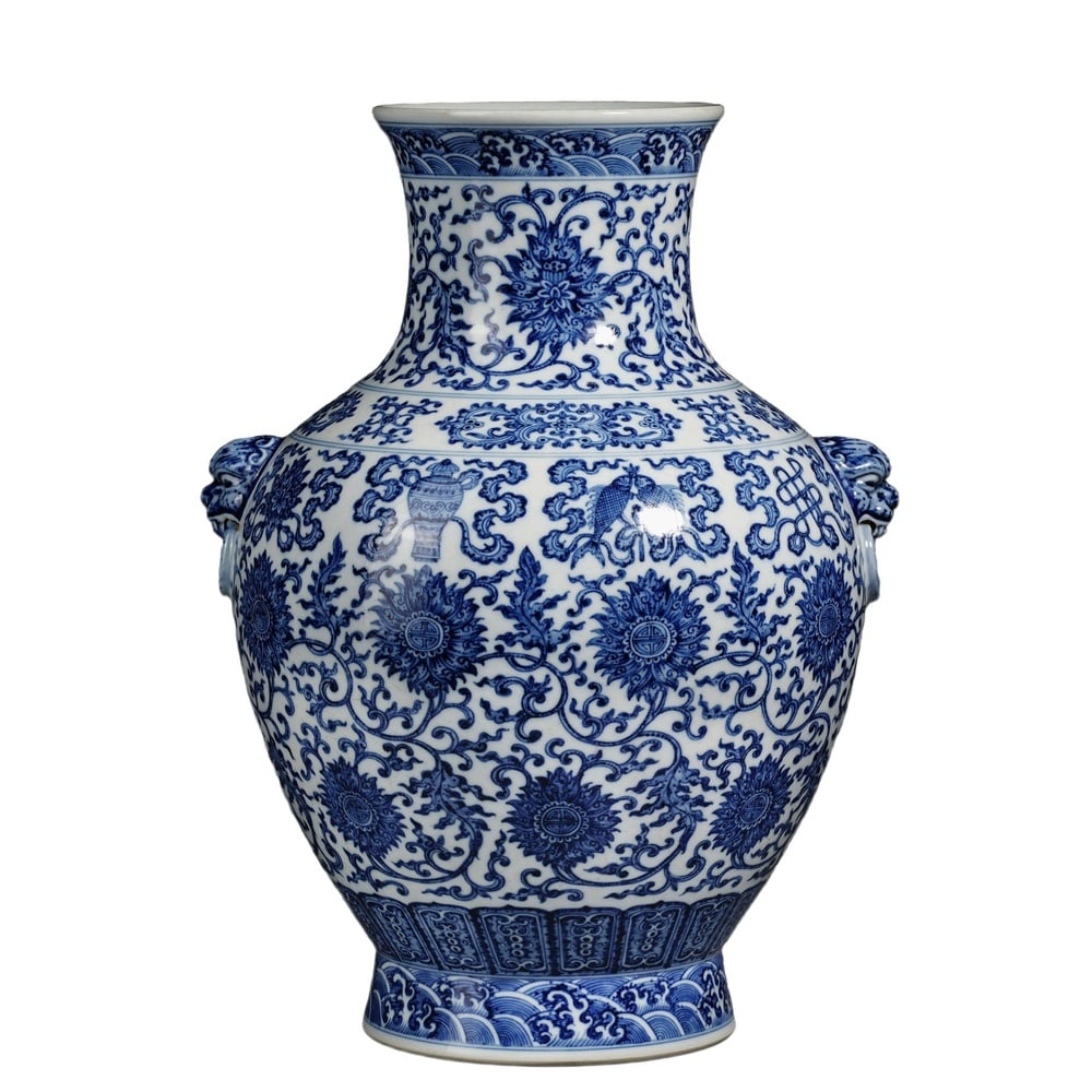 QIANLONG BLUE AND WHITE 'LOTUS SCROLL' ZUN WITH ANIMAL-MASK HANDLES: Qianlong Blue and White 'Lotus Scroll' Zun with Animal-Mask Handles Dimensions: H: 14 1/2 in (37 cm); W: 10 5/8 in (27 cm) This commanding zun is among the most imposing blue-and-white forms produced 