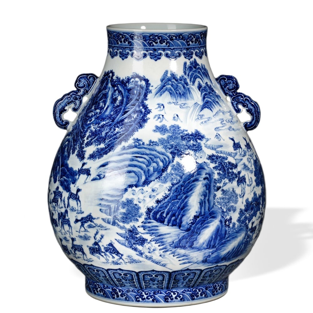 QIANLONG BLUE AND WHITE 'HUNDRED DEER' ZUN WITH ELEPHANT-HEAD HANDLES: Qianlong Blue and White 'Hundred Deer' Zun with Elephant-Head Handles Dimensions: H: 17 3/4 in (45 cm); W: 15 3/4 in (40 cm) This monumental zun is among the most ambitious blue-and-white forms produc