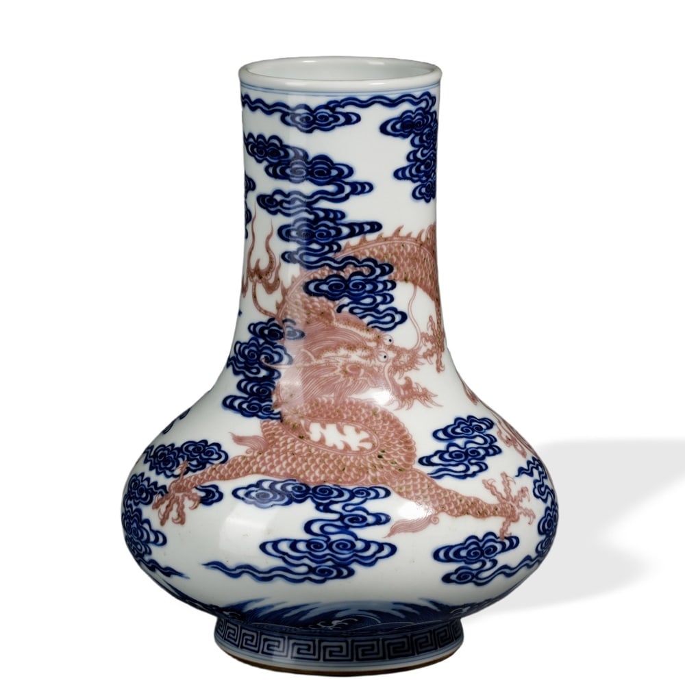 QIANLONG UNDERGLAZE BLUE AND COPPER-RED 'DRAGONS AMONG AUSPICIOUS CLOUDS' WIDE-BELLIED VASE: Qianlong Underglaze Blue and Copper-Red 'Dragons Among Auspicious Clouds' Wide-Bellied Vase Dimensions: H: 9 3/4 in (25 cm); W: 7 3/4 in (20 cm) This handsomely proportioned vase exemplifies one of