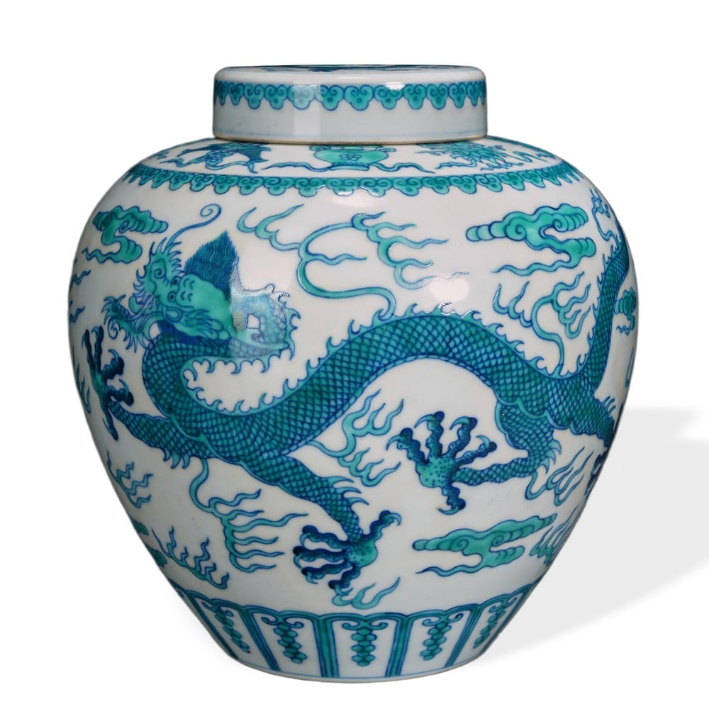 DOUCAI 'GREEN DRAGON CHASING THE FLAMING PEARL' LIDDED JAR WITH EIGHT BUDDHIST TREASURES: Doucai 'Green Dragon Chasing the Flaming Pearl' Lidded Jar with Eight Buddhist Treasures Dimensions: H: 7 1/2 in (19 cm); W: 6 3/4 in (17 cm) This handsomely proportioned lidded jar exemplifies the do