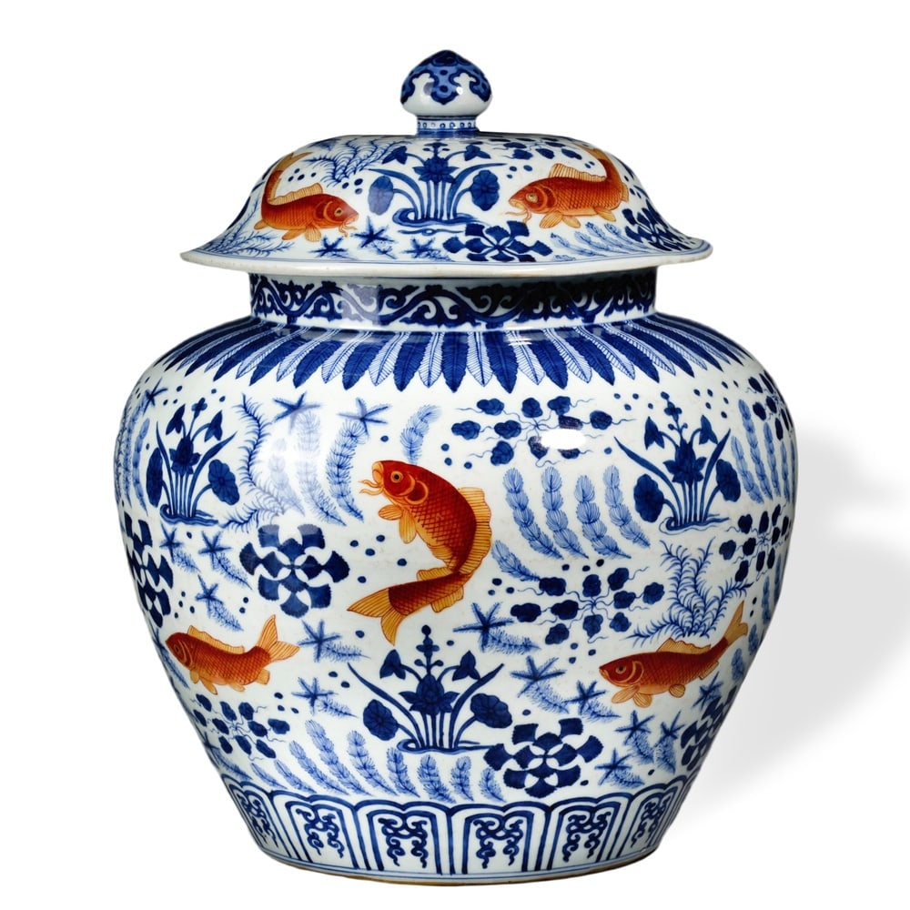 MING JIAJING PERIOD UNDERGLAZE BLUE AND IRON-RED 'FISH AND ALGAE' LIDDED JAR: Ming Jiajing Period Underglaze Blue and Iron-Red 'Fish and Algae' Lidded Jar Dimensions: H: 16 1/4 in (41 cm); W: 15 3/4 in (40 cm) This impressive lidded jar represents one of the most celebrated dec