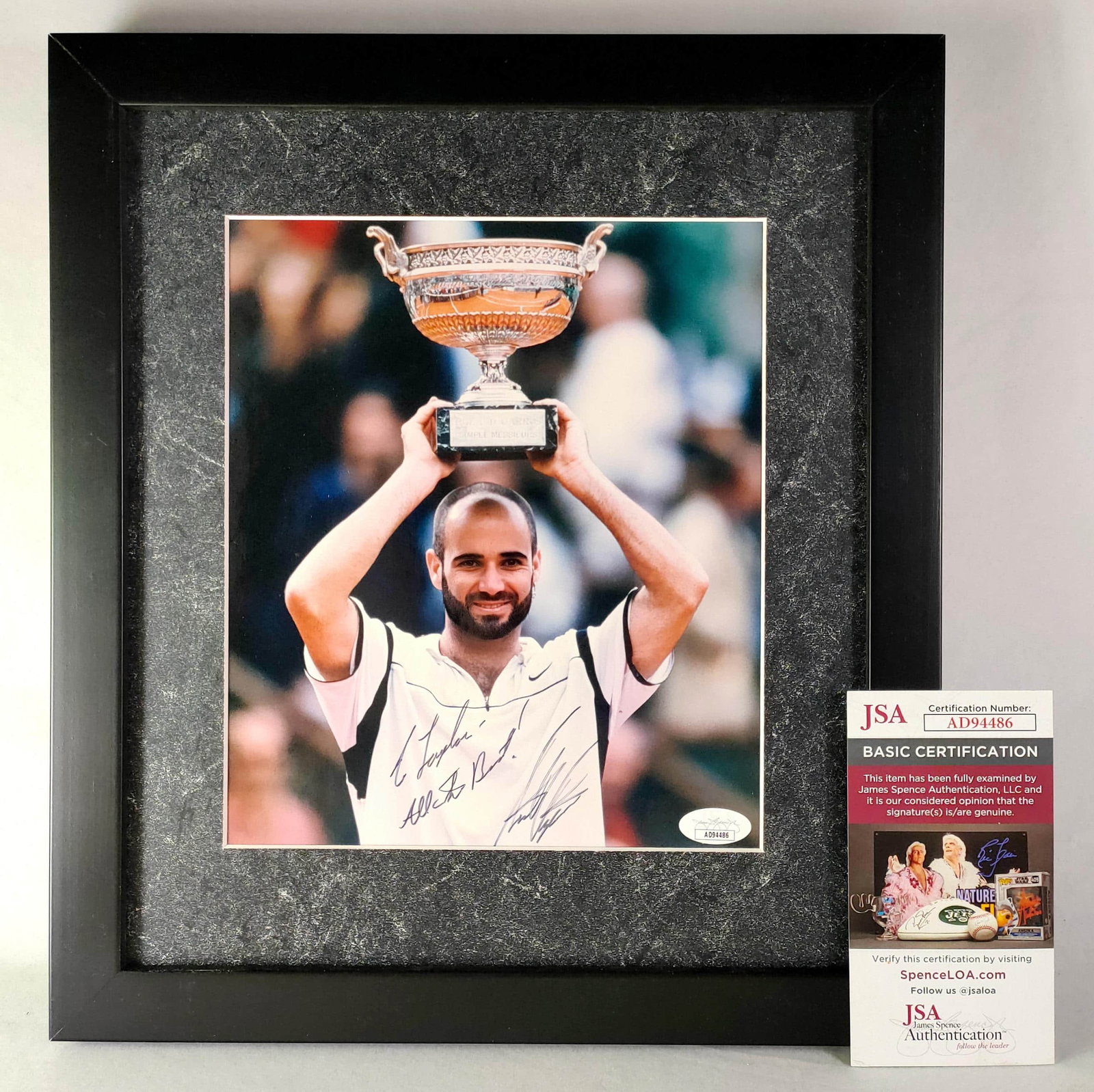 . photo of Agassi, the first golden slam winner in tennis history -JSA identification: . photo of Agassi, the first golden slam winner in tennis history (photo is about 10 inches, framed). The collection is. by Agassi, and the overall frame is about 34.5cm?? 30.5cm, and the photo is abo