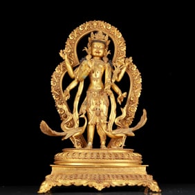 A huge gilt bronze statue of Manjushri with six arms