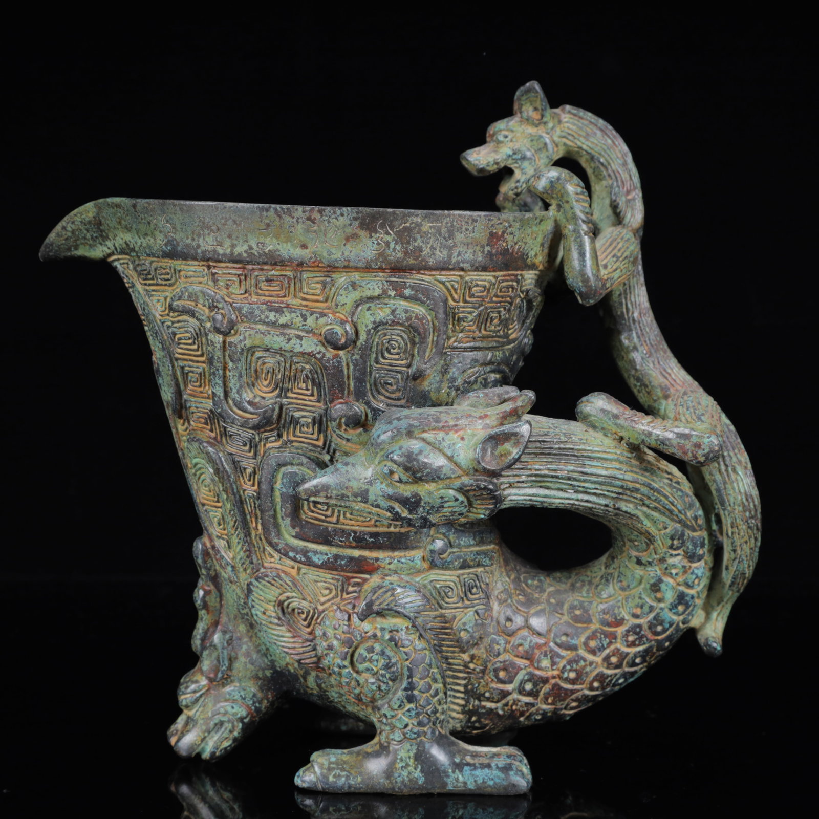 An Archaic Bronze Dragon Cup: An Archaic Bronze Dragon Cup,the Warring States Period in China,Size:10.2inx9.8inx9.4in,Weight:3750g 青铜龙杯,中国战国时期