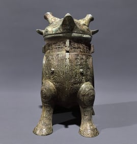An Archaic Bronze Cloud and Thunder Pattern Ancient Owl-Shaped Zun