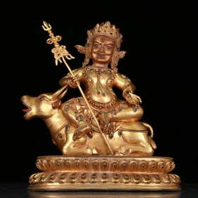 A stunning gilt bronze statue of Vajra riding a bull