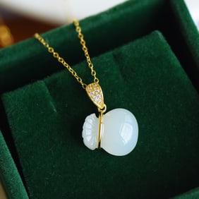 An Exquisite Gilt Silver Inlaid White Jade Pendant