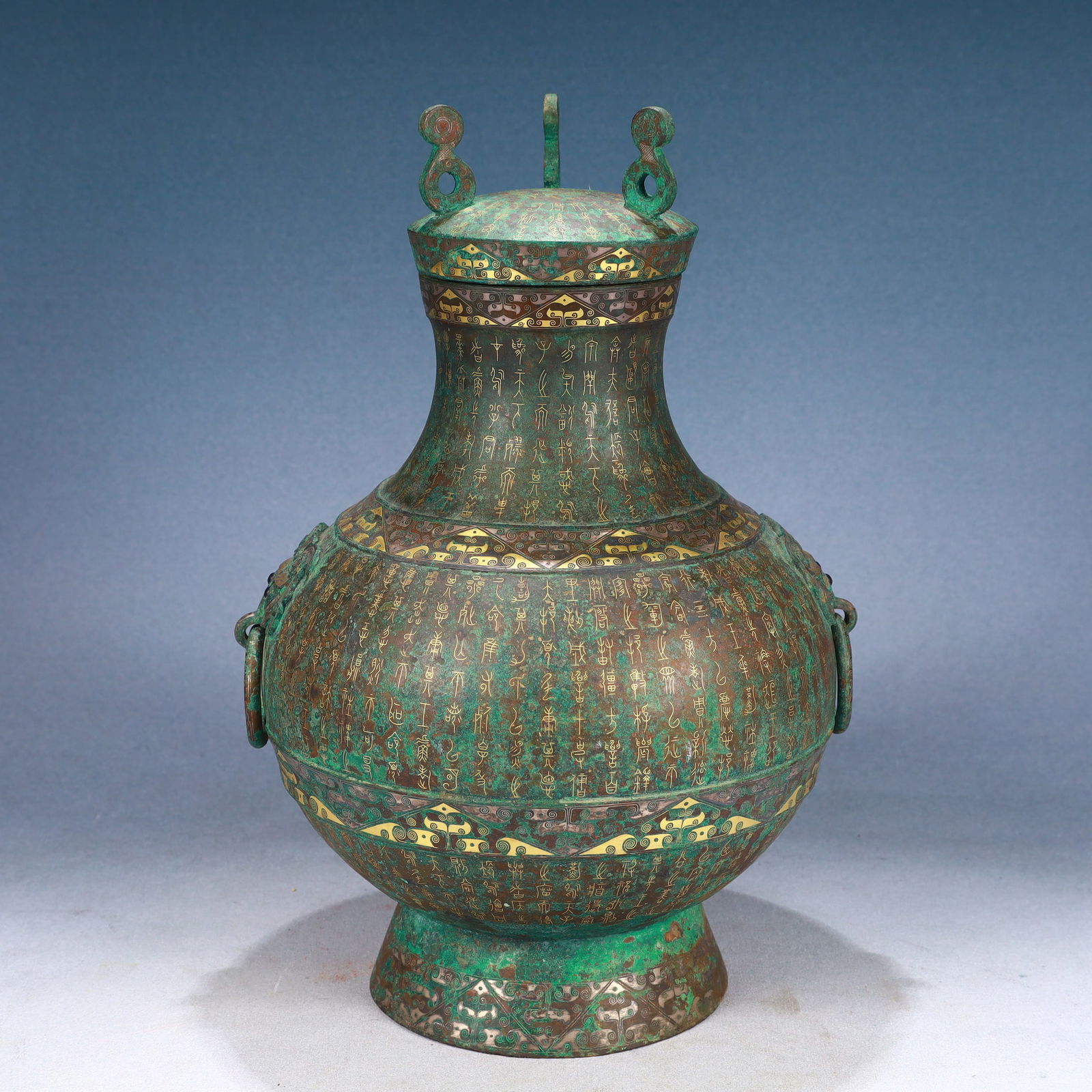 An Archaic Bronze Inlaid Gold and Silver Poem Dragon Pattern Beast-Ears Cover Jar: An Archaic Bronze Inlaid Gold and Silver Poem Dragon Pattern Beast-Ears Cover Jar,Qing Dynasty, China,Size:8.7inx14.2in,Weight:3900g 青铜错金银诗文龙