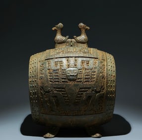 An Archaic Bronze Human-face Pattern Four Legs Ornament