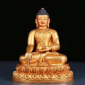 A solemn gilt bronze statue of Sakyamuni