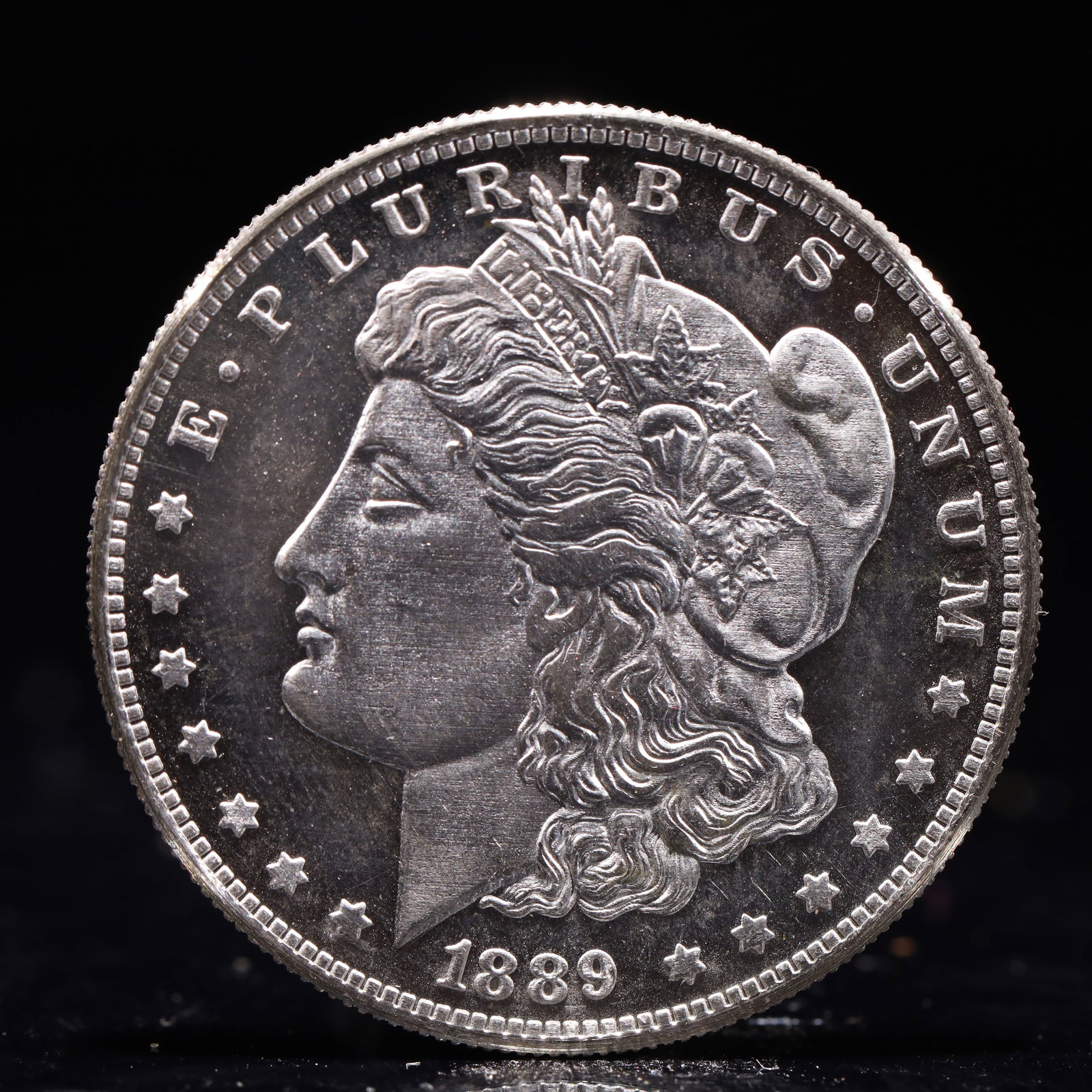 USA Morgan Dollar 1889 Coin: Obv: profile bust with date below and E PLURIBUS UNUM legend and stars around. Rev: eagle with In God we trust above within wreath with UNITED STATES OF AMERICA ONE DOLLAR legend. IN GOD WE TRUST /