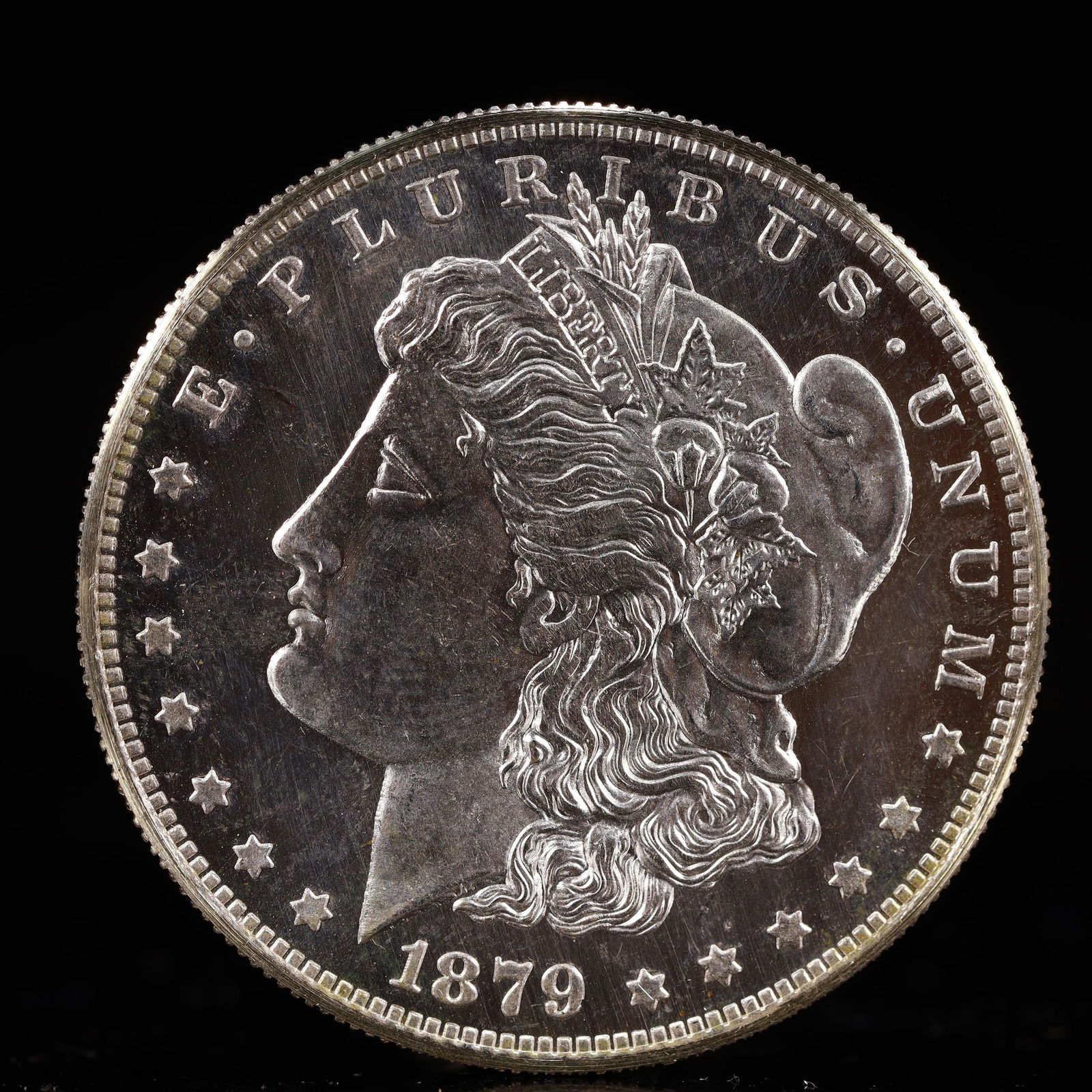USA Morgan Dollar 1879 Coin: Obv: profile bust with date below and E PLURIBUS UNUM legend and stars around. Rev: eagle with In God we trust above within wreath with UNITED STATES OF AMERICA ONE DOLLAR legend. IN GOD WE TRUST /