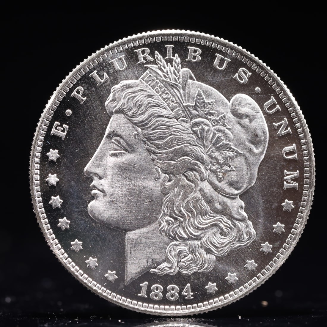 USA Morgan Dollar 1884 Coin: Obv: profile bust with date below and E PLURIBUS UNUM legend and stars around. Rev: eagle with In God we trust above within wreath with UNITED STATES OF AMERICA ONE DOLLAR legend. IN GOD WE TRUST /