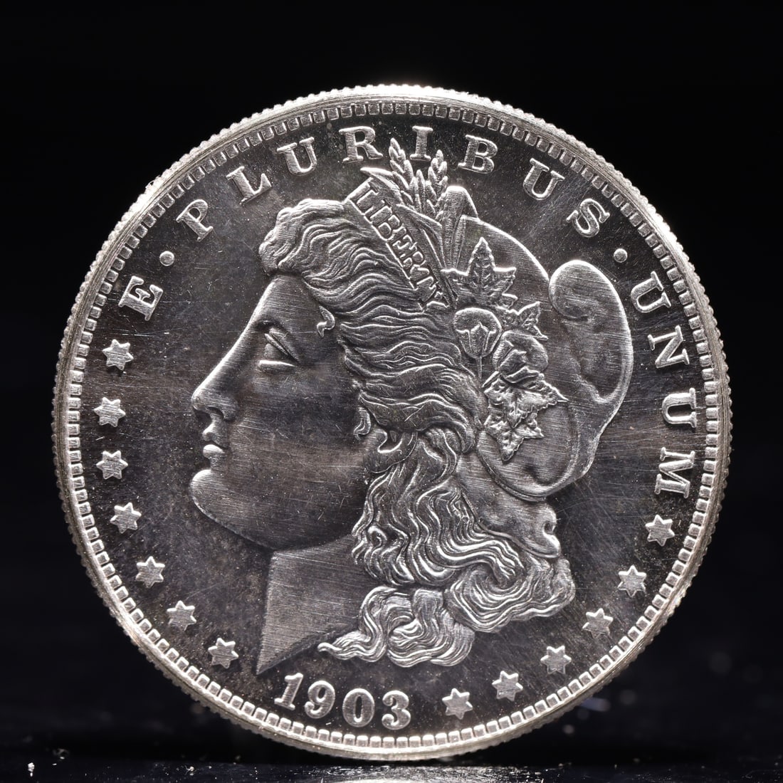 USA Morgan Dollar 1903 Coin: Obv: profile bust with date below and E PLURIBUS UNUM legend and stars around. Rev: eagle with In God we trust above within wreath with UNITED STATES OF AMERICA ONE DOLLAR legend. IN GOD WE TRUST /